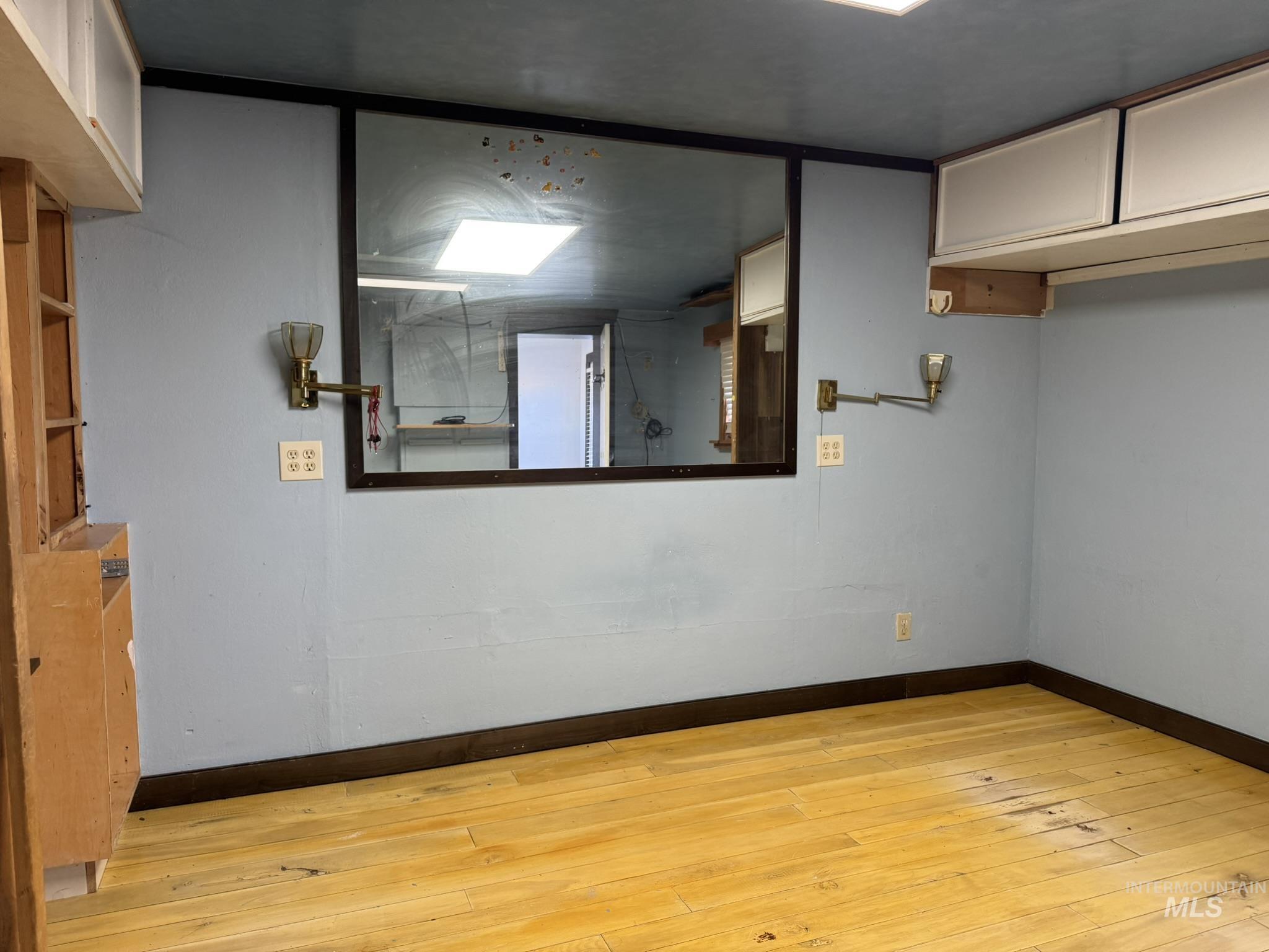 Empty room featuring light wood-style flooring and baseboards