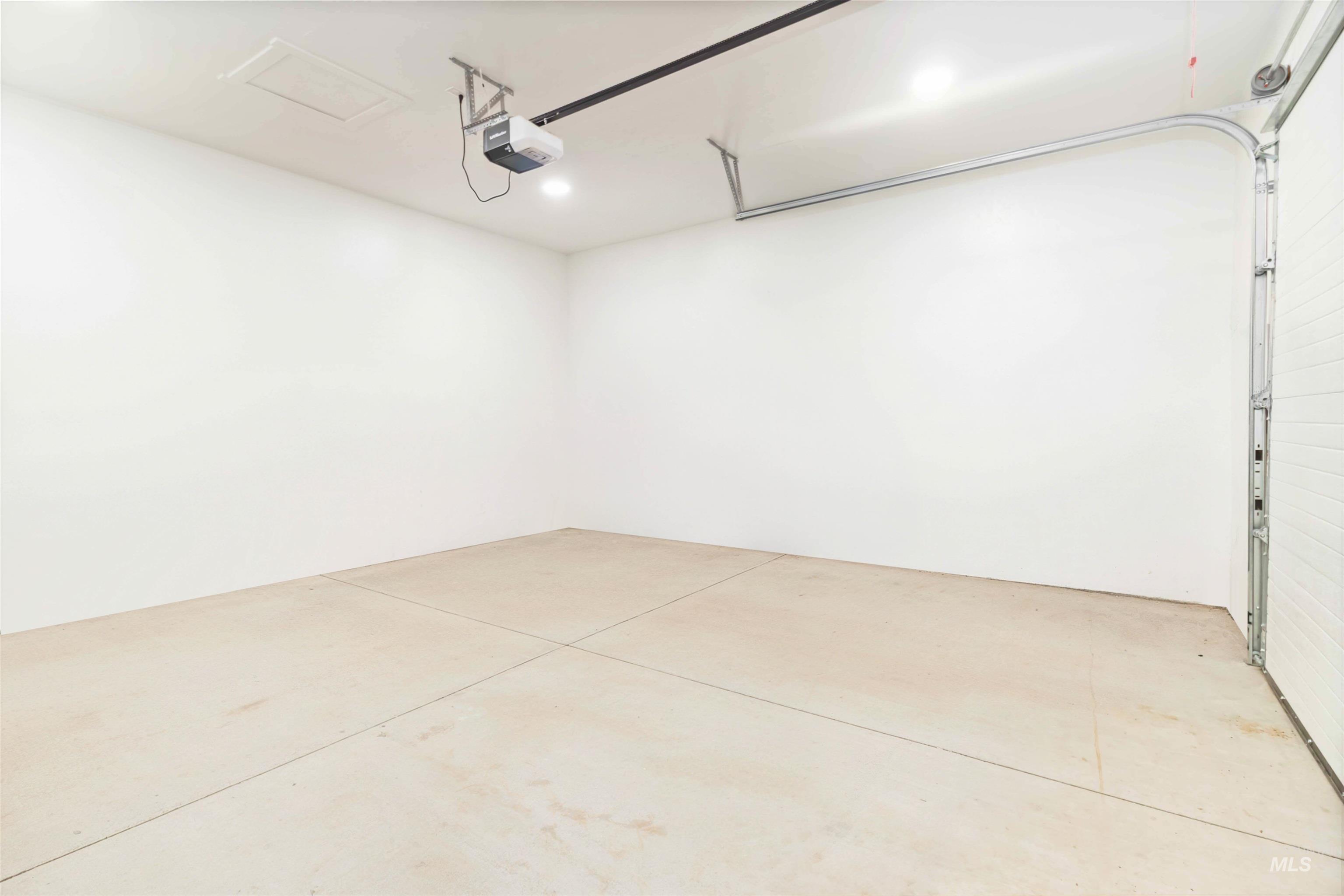 Garage featuring a garage door opener