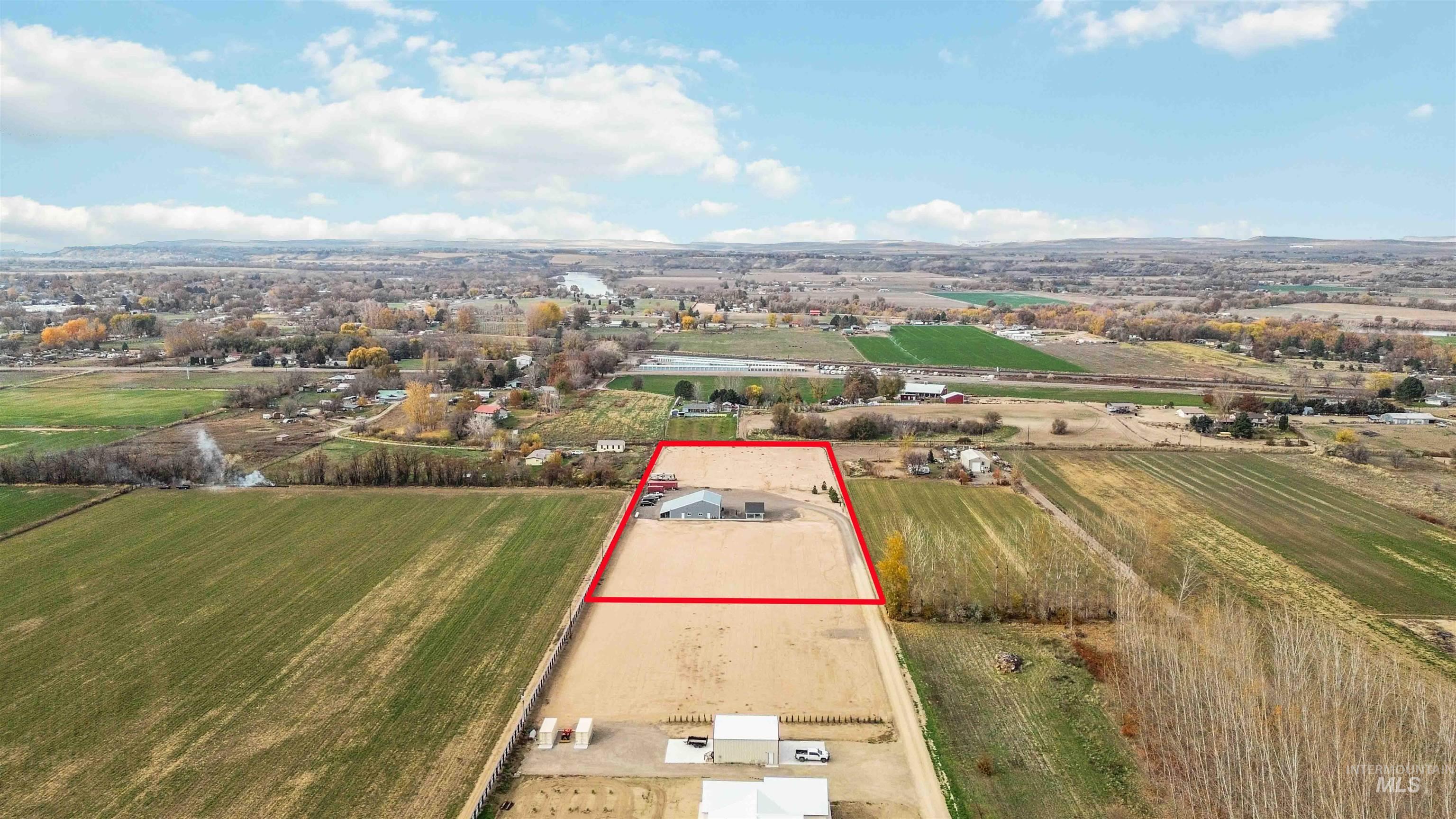 Aerial view of sparsely populated area with property parcel outlined and abundant farmland