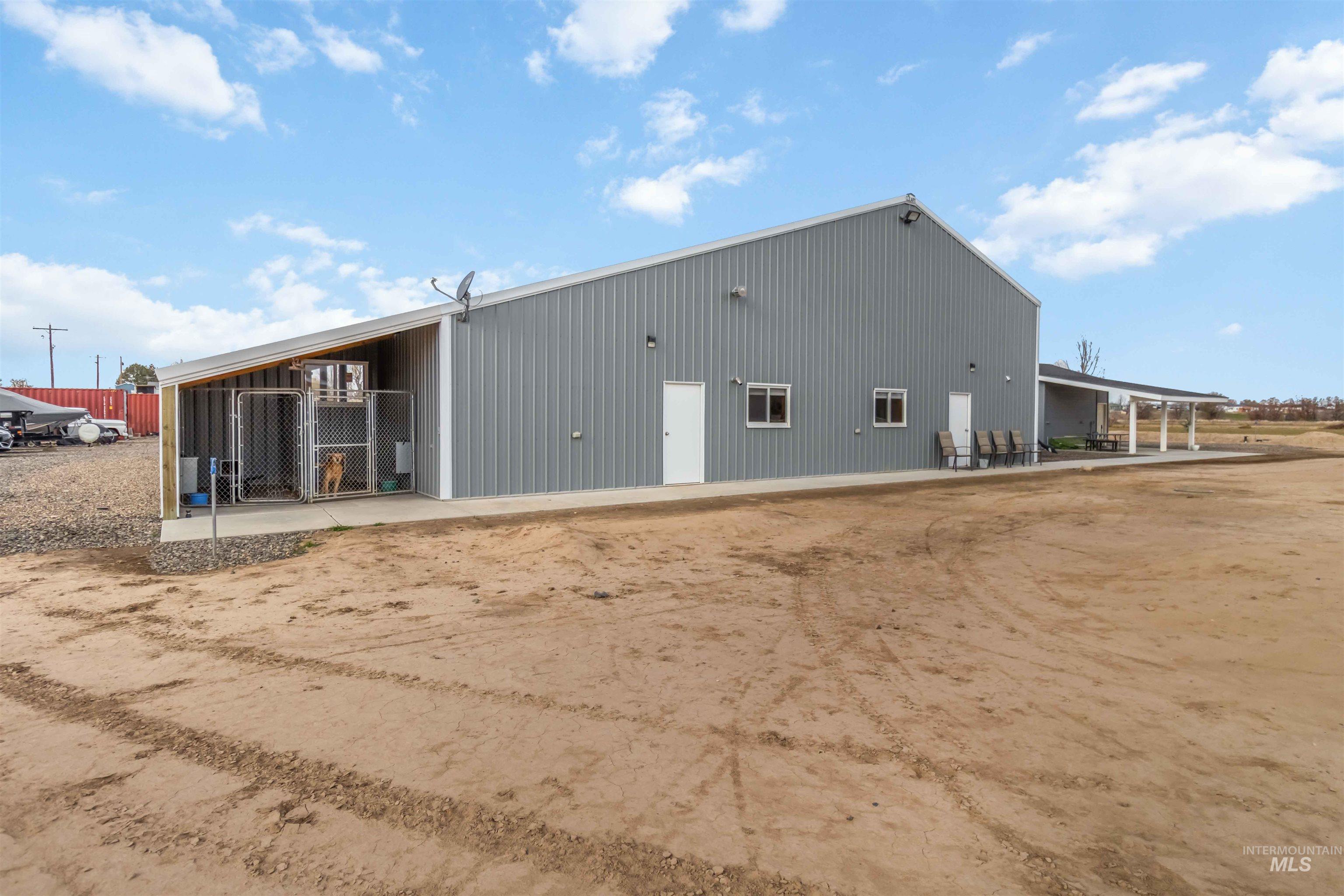 Rear view of house featuring a patio and an outdoor structure