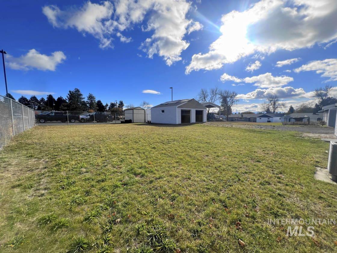 Fenced backyard with an outbuilding