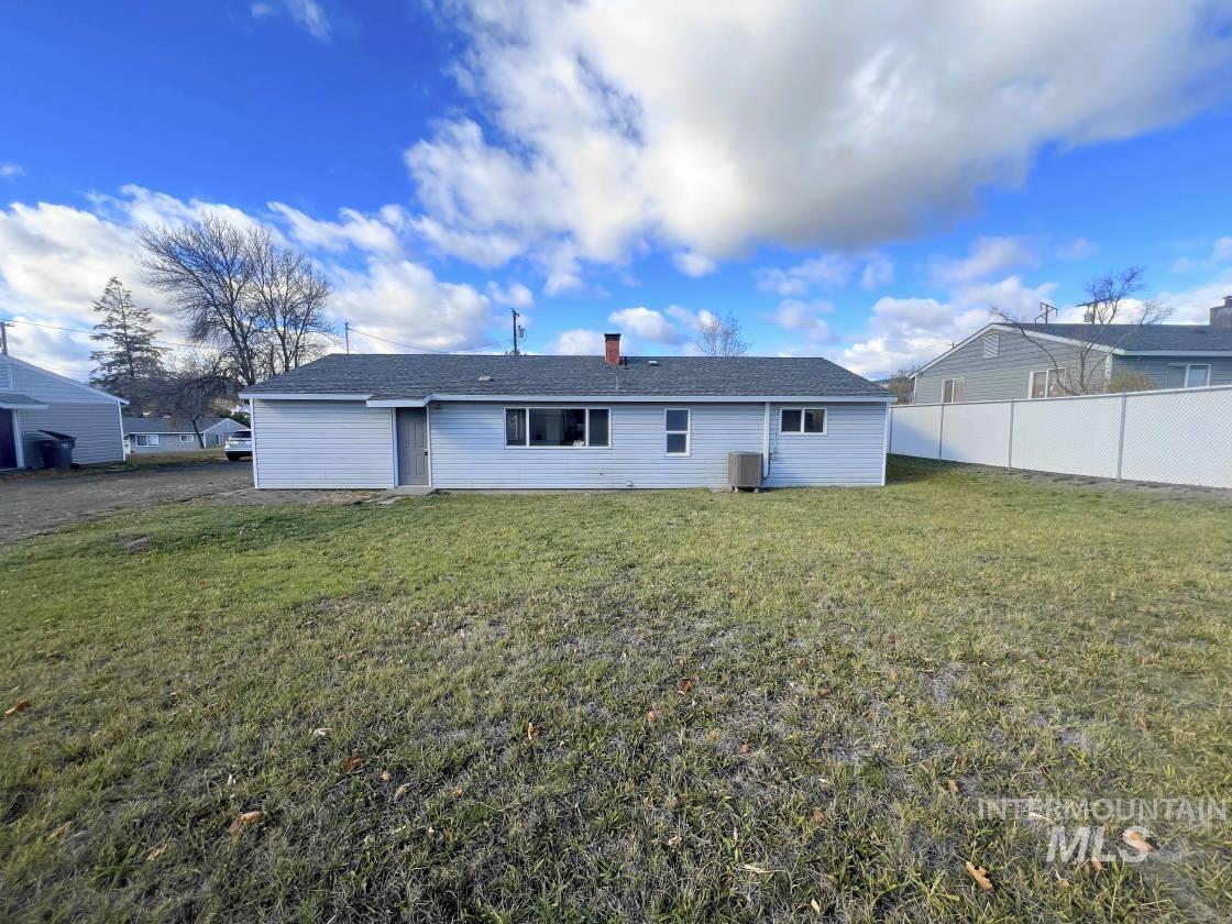 Rear view of house featuring a chimney