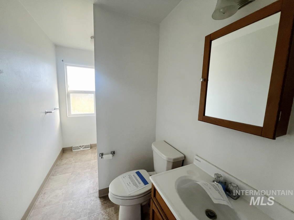Bathroom with vanity and baseboards