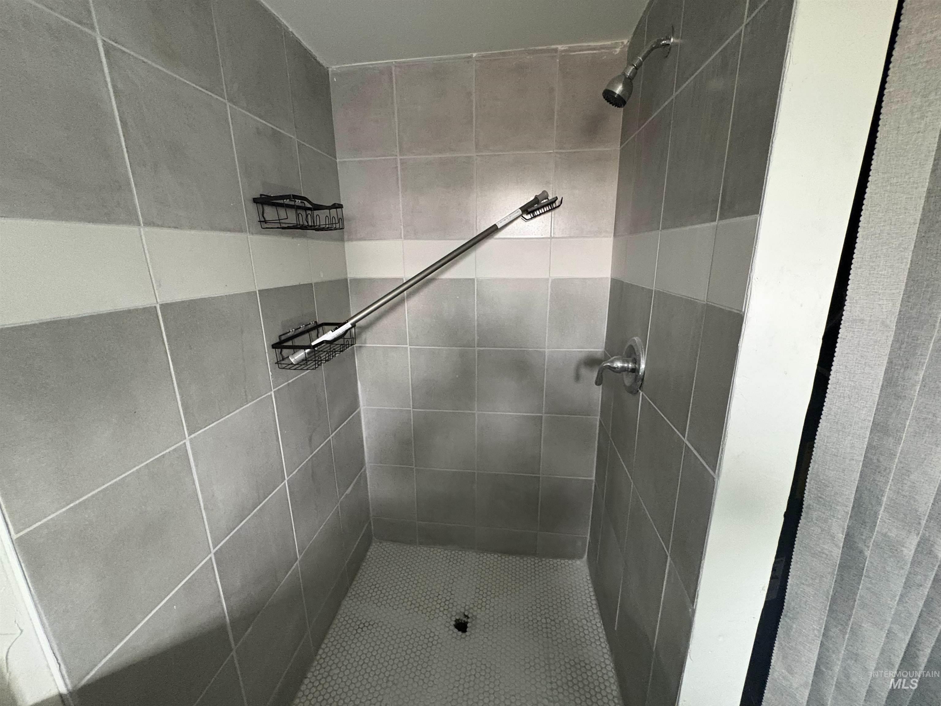 Full bathroom with a shower stall