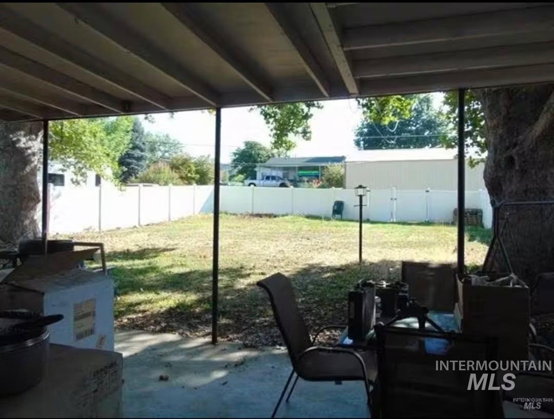 Fenced backyard featuring a patio