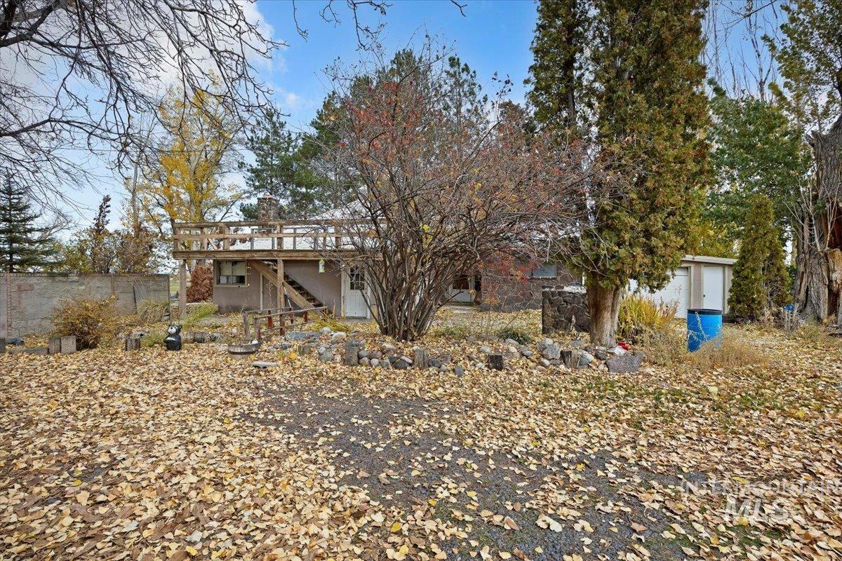 Rear view of property with a deck and stairs