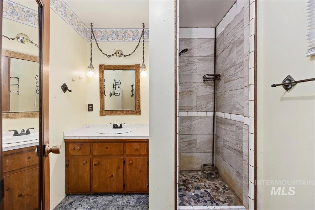 Bathroom featuring a stall shower and vanity