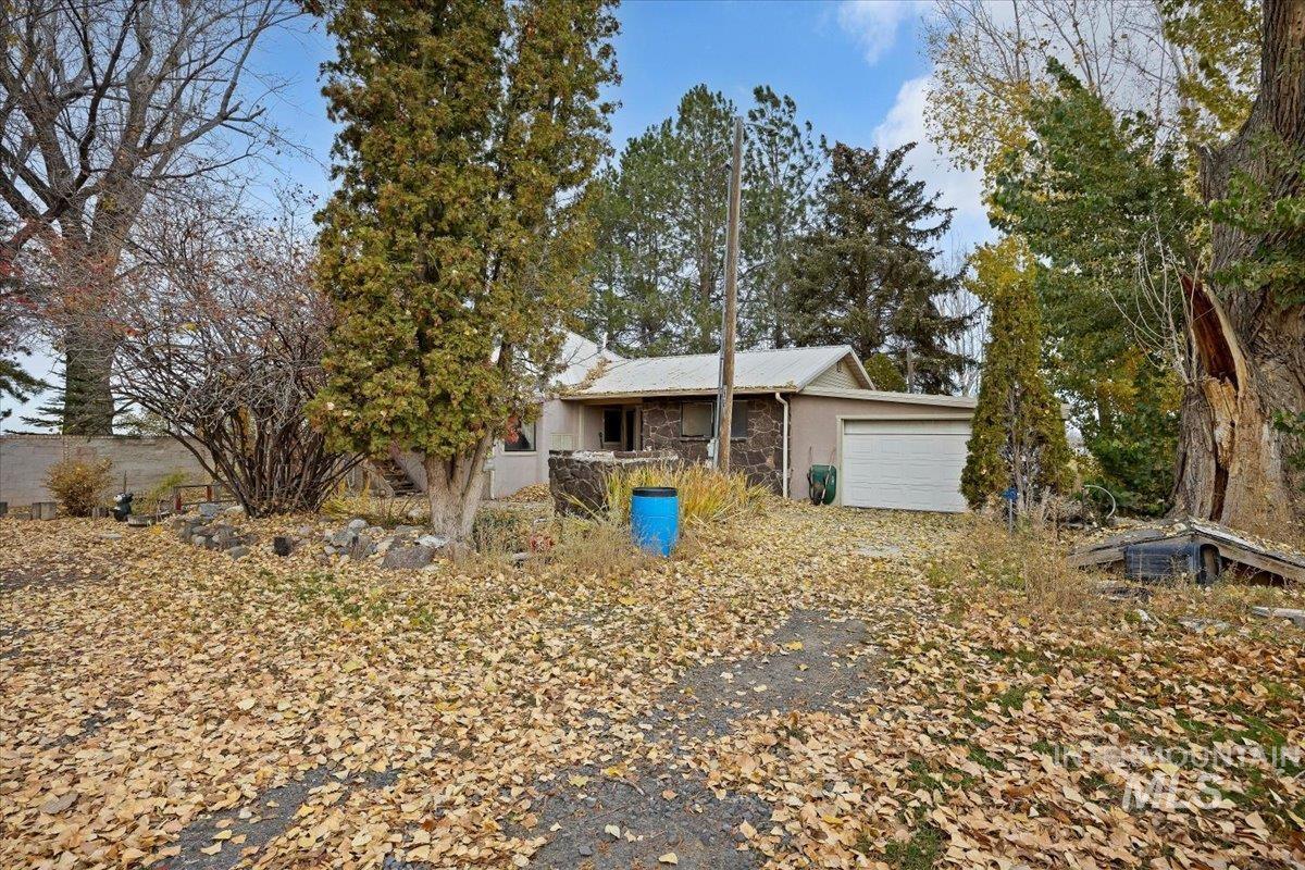 Single story home featuring stone siding and a garage