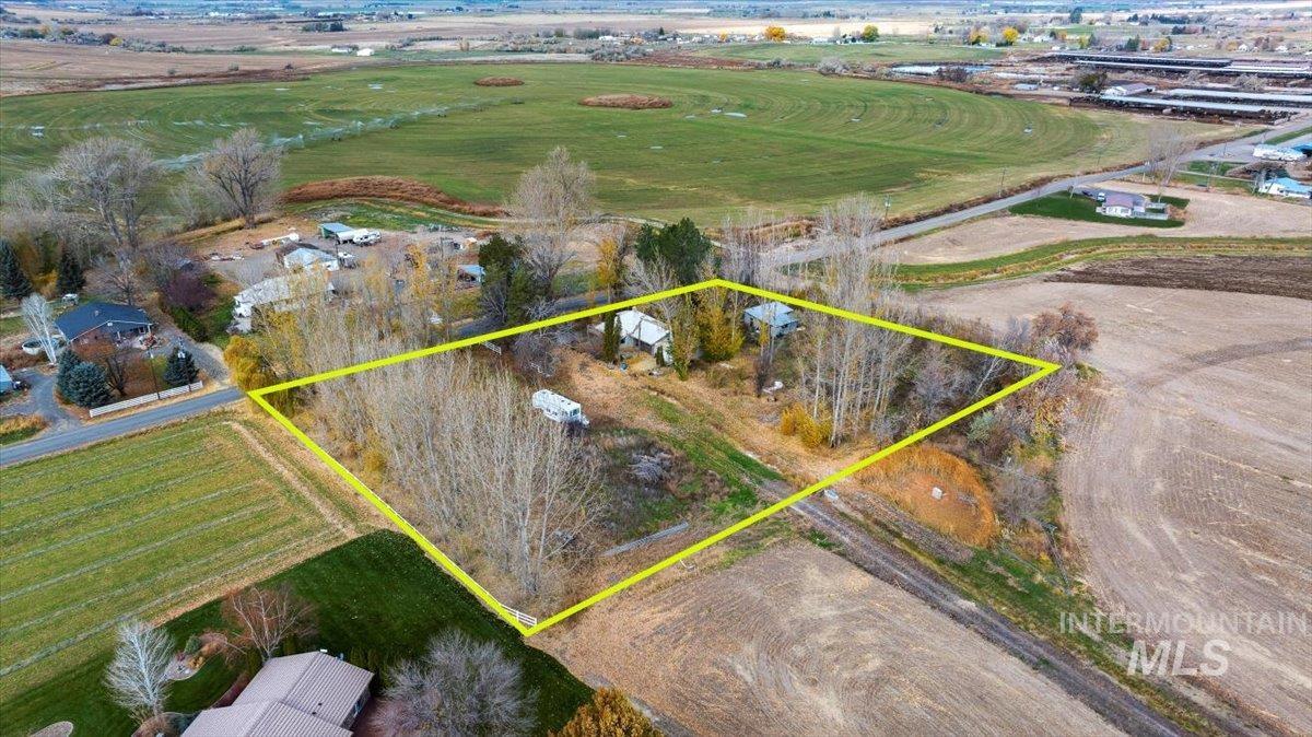 Overview of rural landscape featuring property parcel outlined and large plots for crops