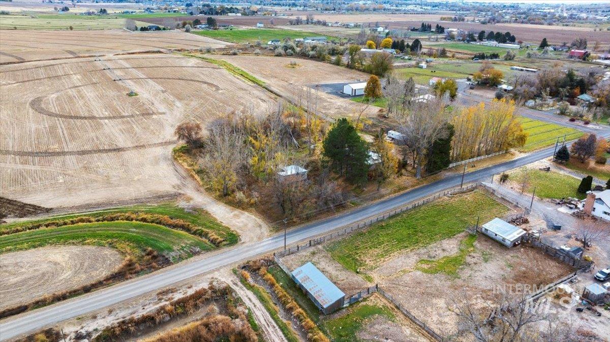 Aerial view of property and surrounding area featuring rural landscape and extensive farmland