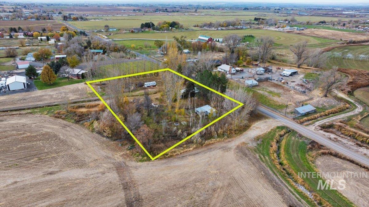 Aerial view of sparsely populated area with property parcel outlined