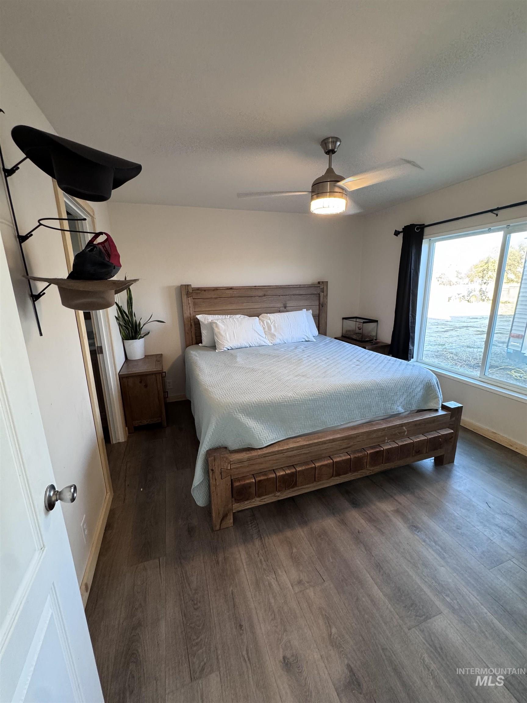 Bedroom with wood finished floors and ceiling fan