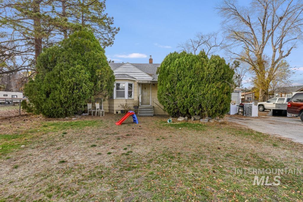 Obstructed view of property featuring a chimney, a shingled roof, and entry steps