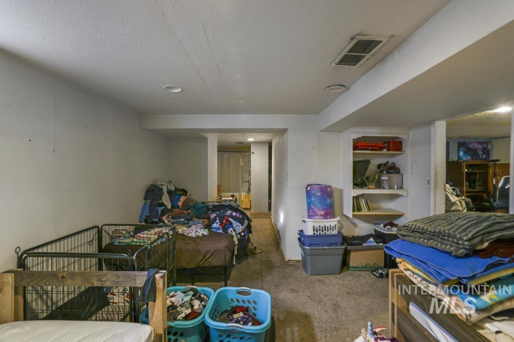 Carpeted bedroom featuring a textured ceiling