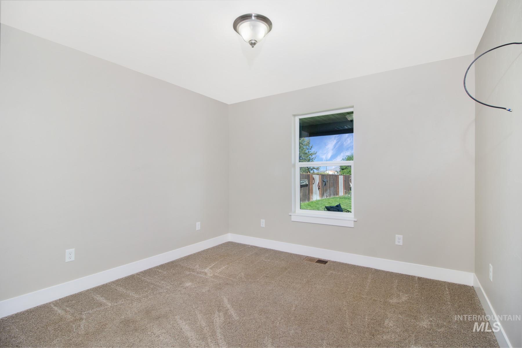 Empty room featuring light colored carpet