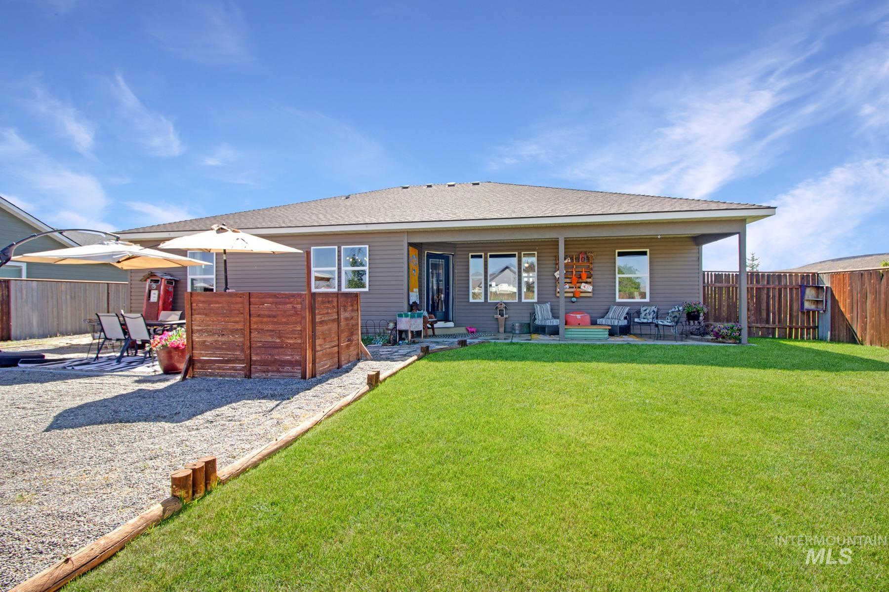 Back of house with a patio, an outdoor hangout area, a fenced backyard, and a shingled roof