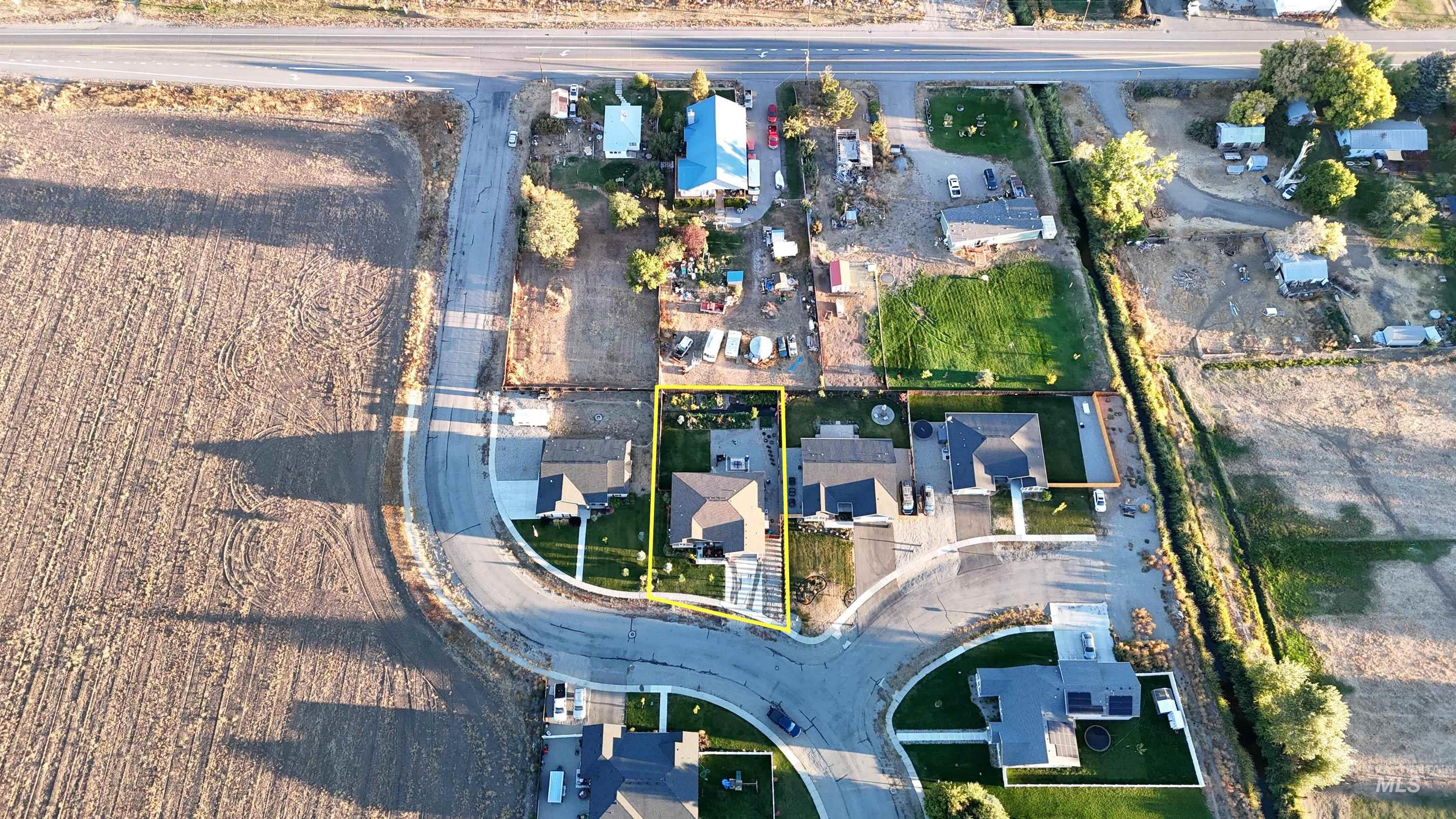 Aerial view of property and surrounding area featuring property boundaries highlighted