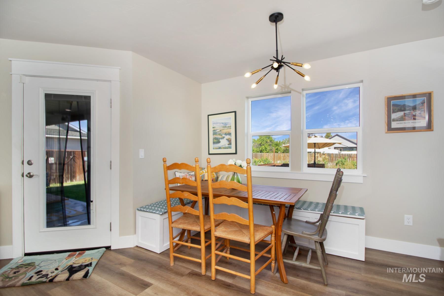 Dining room featuring dark wood finished floors, a chandelier, and breakfast area