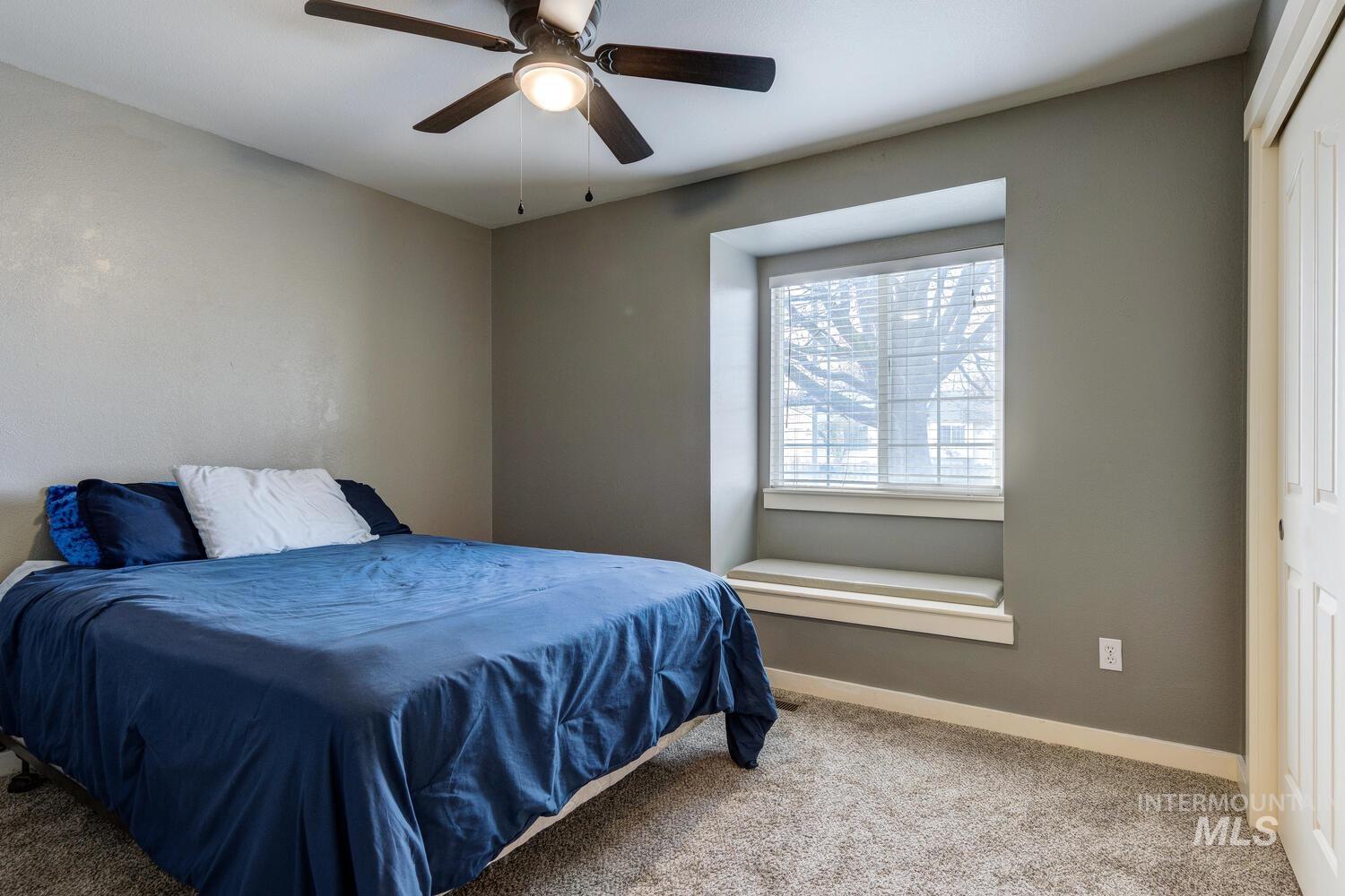 Bedroom with carpet flooring and a ceiling fan