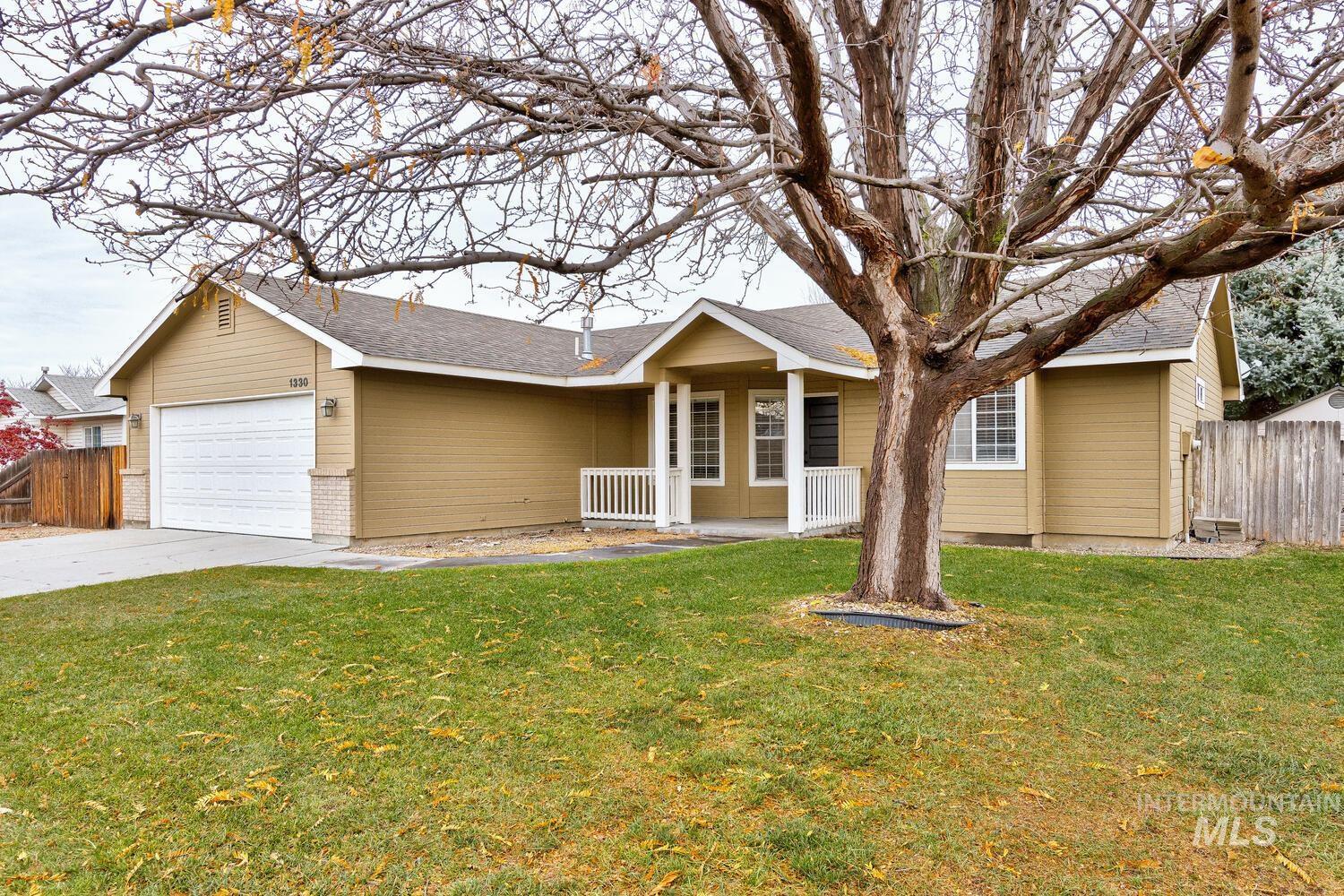 Single story home with concrete driveway, a garage, a shingled roof, and a porch