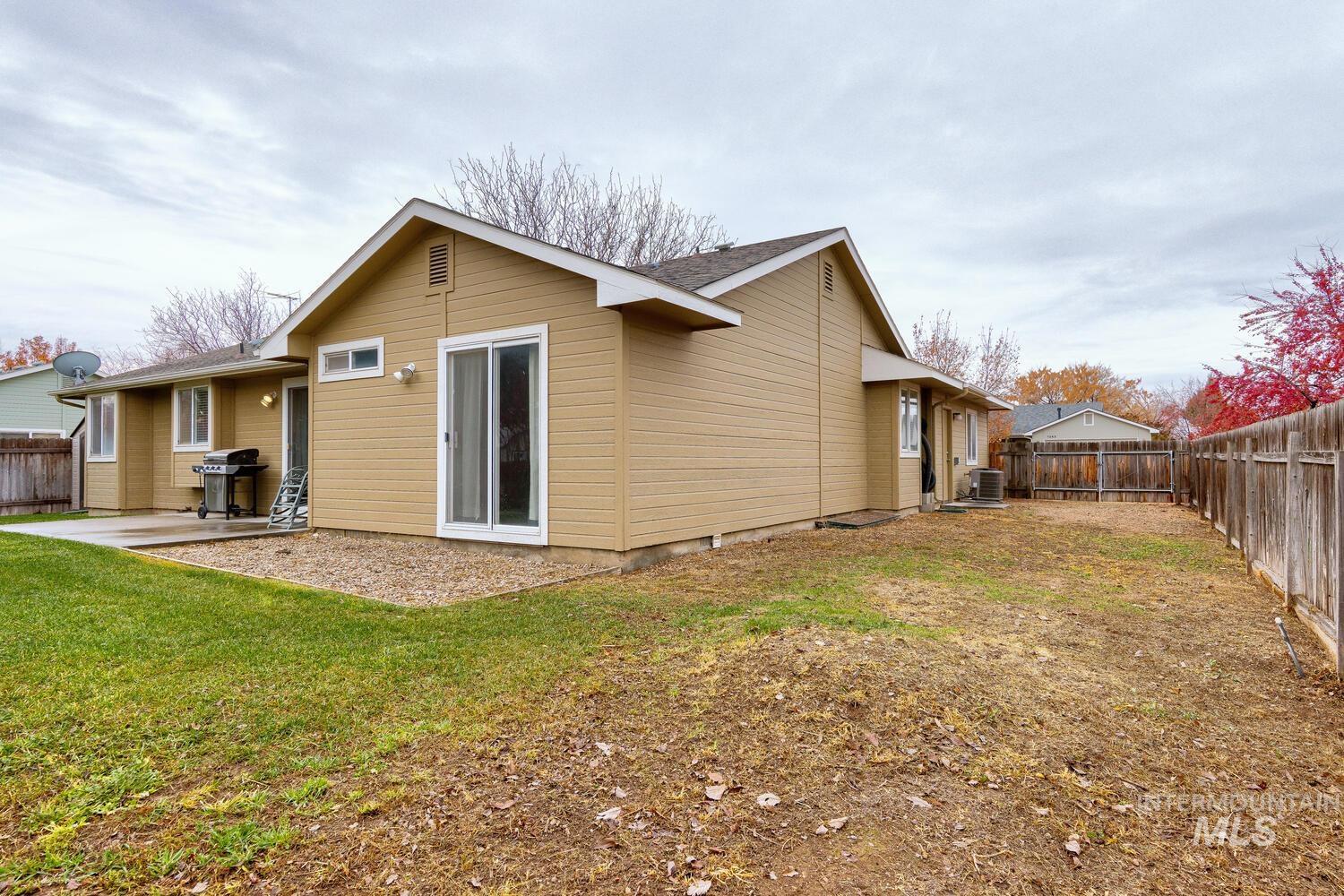 Back of house with a fenced backyard