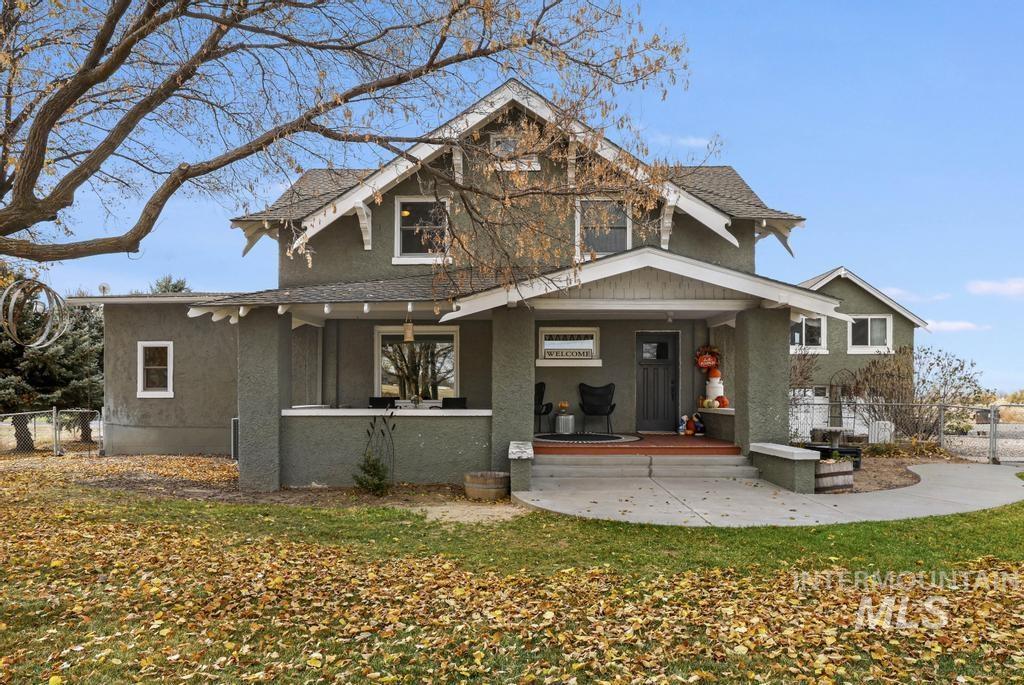 View of front of home featuring stucco siding and a shingled roof