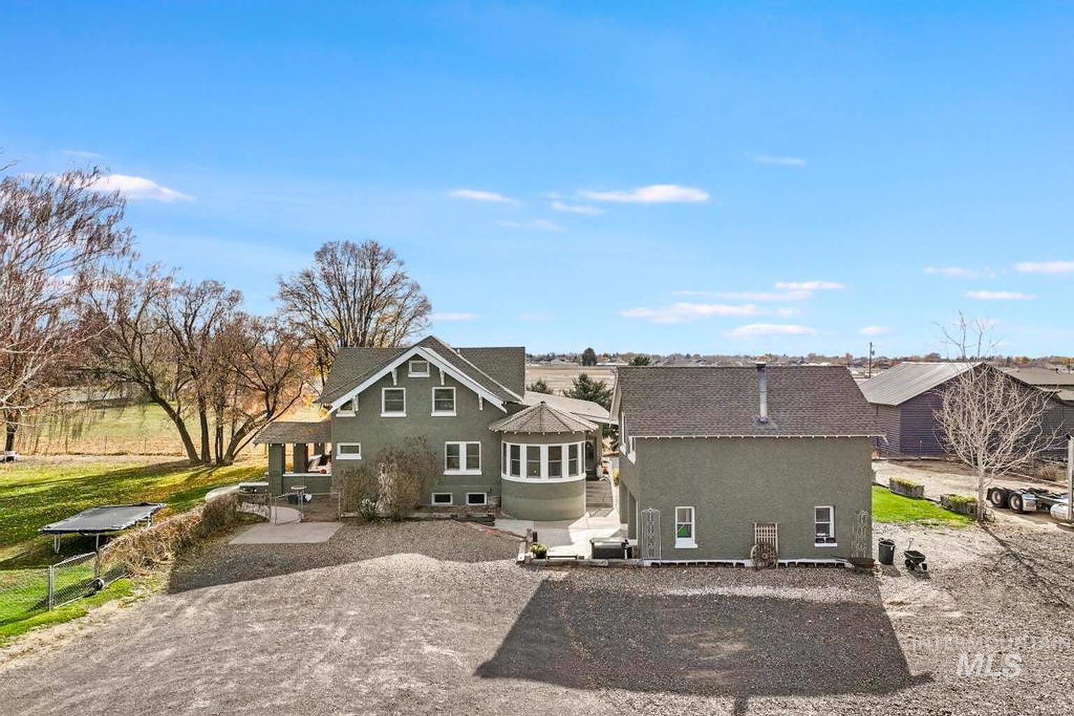 Rear view of house with a patio area and stucco siding