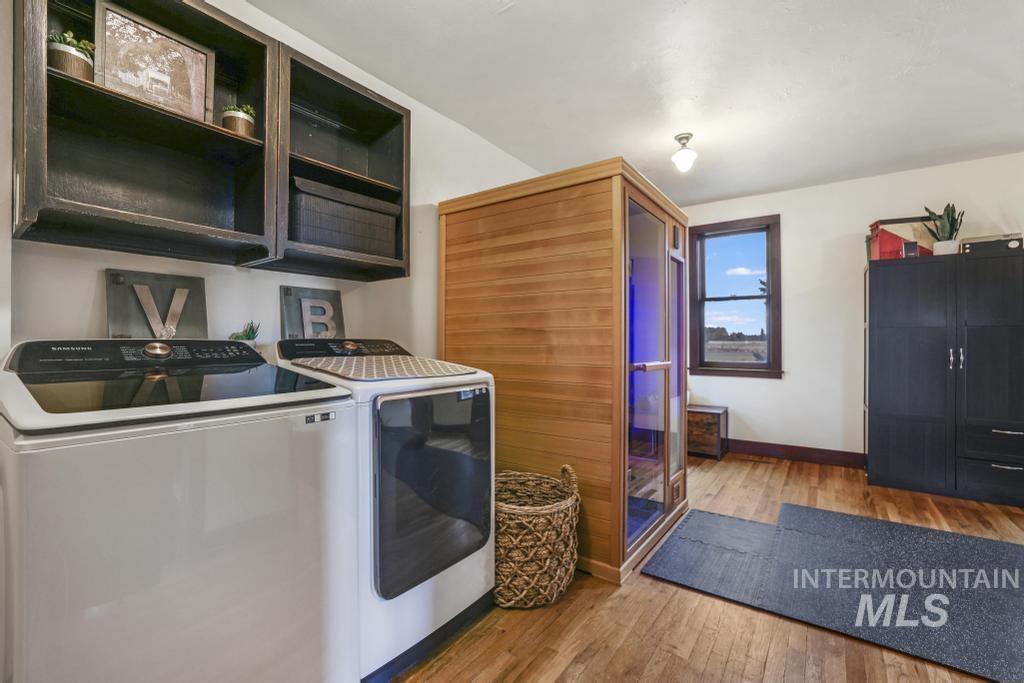 Laundry room featuring light wood-type flooring and washer and dryer