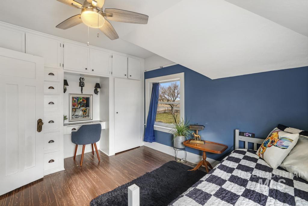 Bedroom featuring dark wood-type flooring, ceiling fan, and lofted ceiling