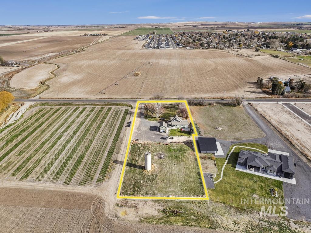 Aerial view of sparsely populated area featuring farmland and property boundaries highlighted