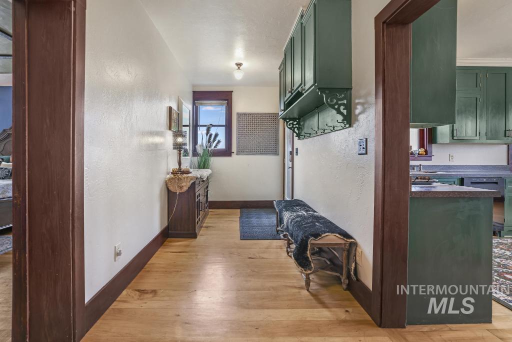 Hall with a textured wall and light wood finished floors