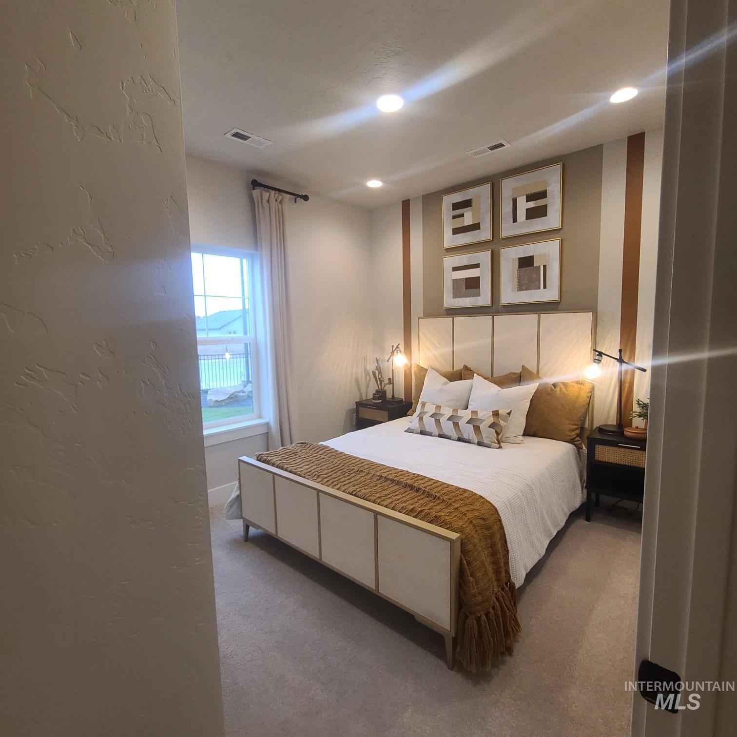 Bedroom with carpet flooring and a textured wall