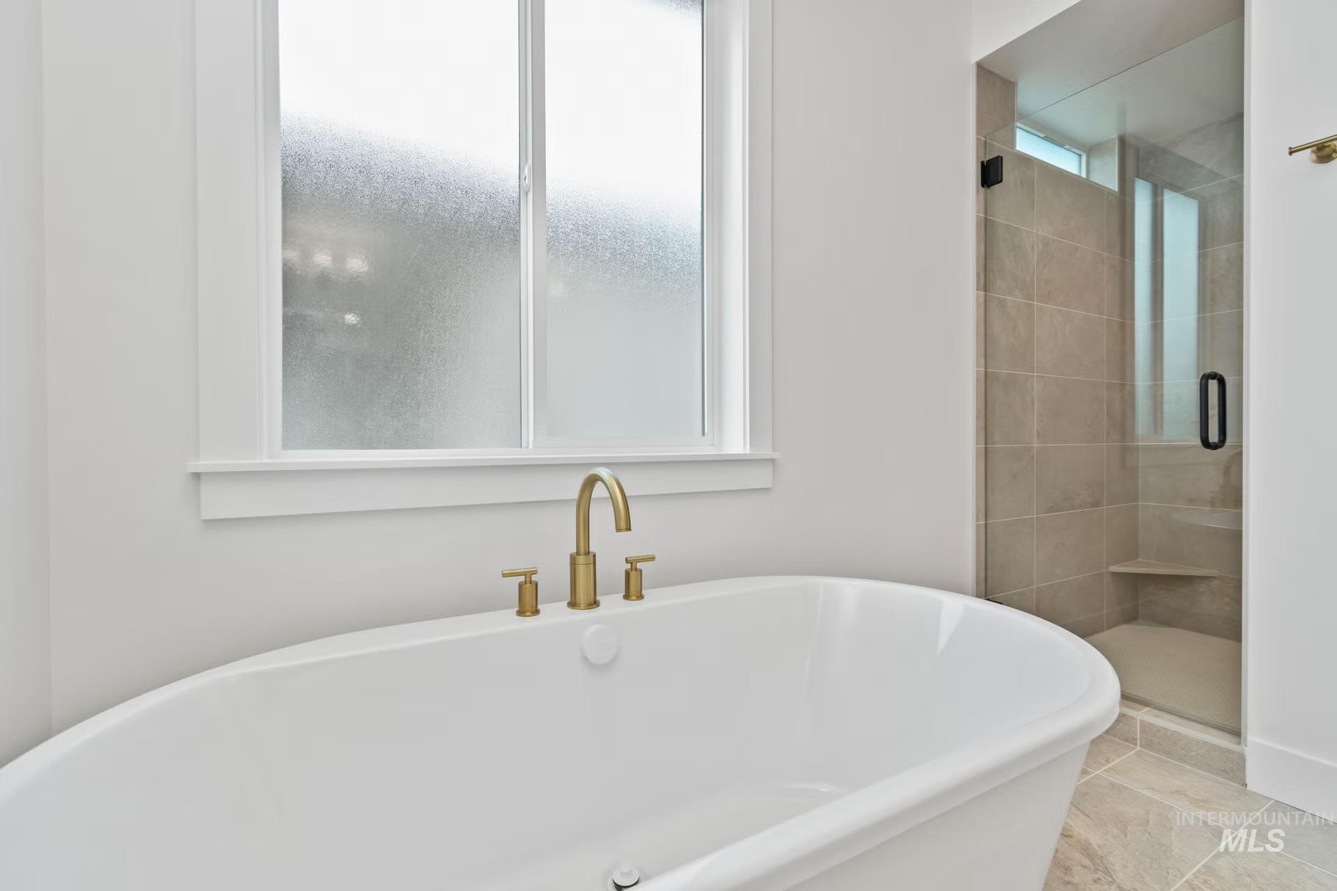 Bathroom with a soaking tub and a stall shower
