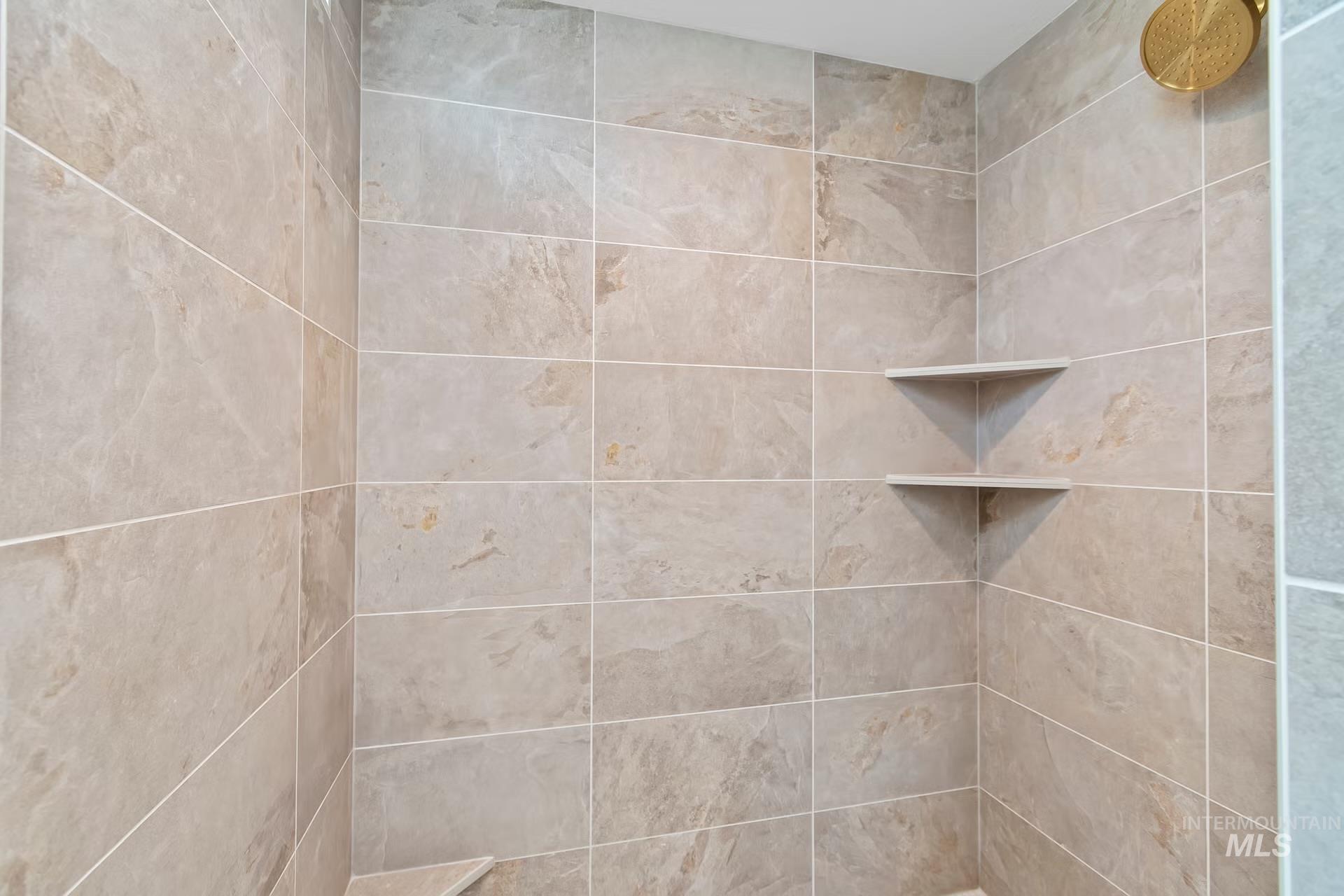 Full bath featuring a tile shower