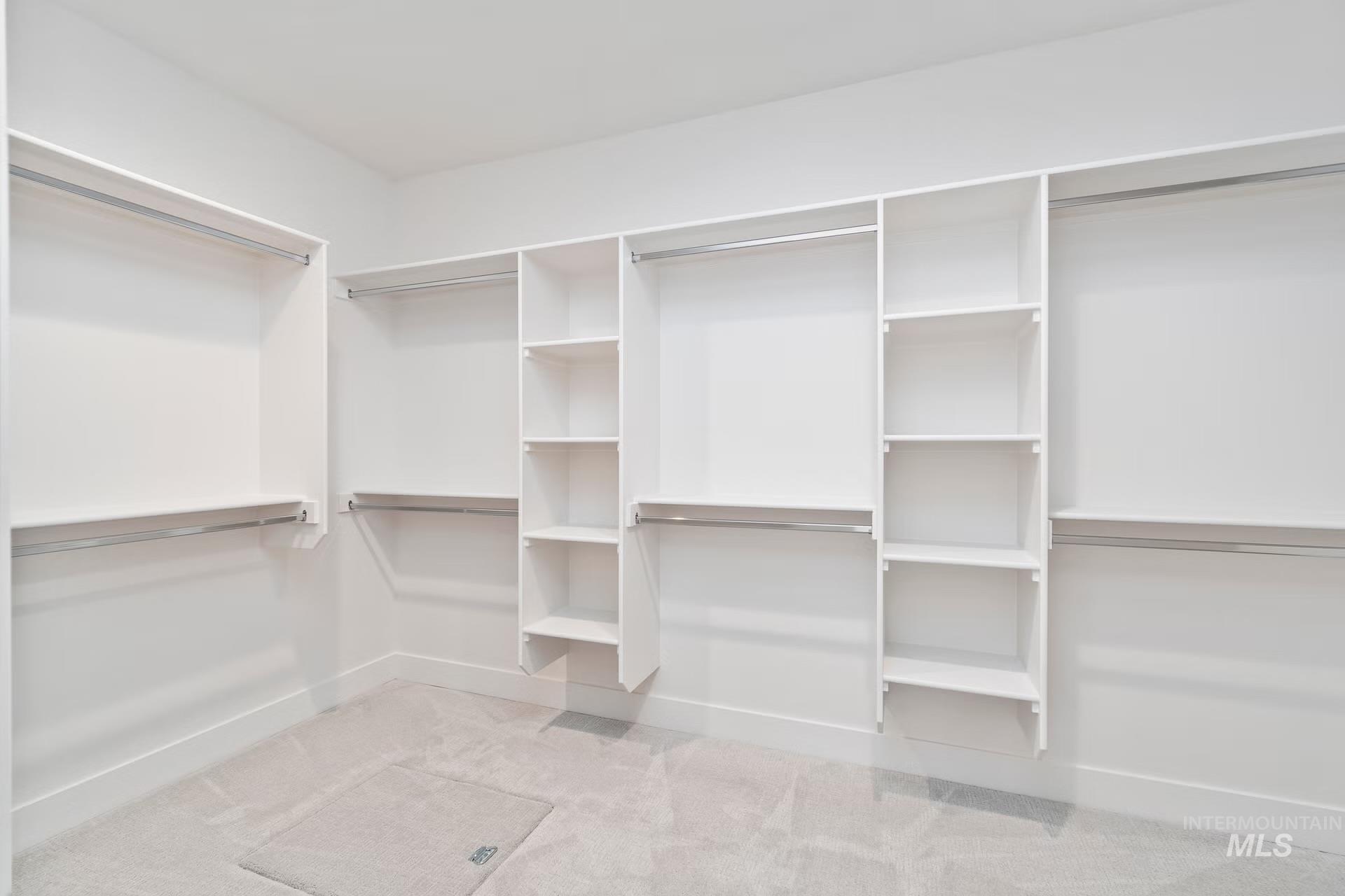 Spacious closet with light colored carpet