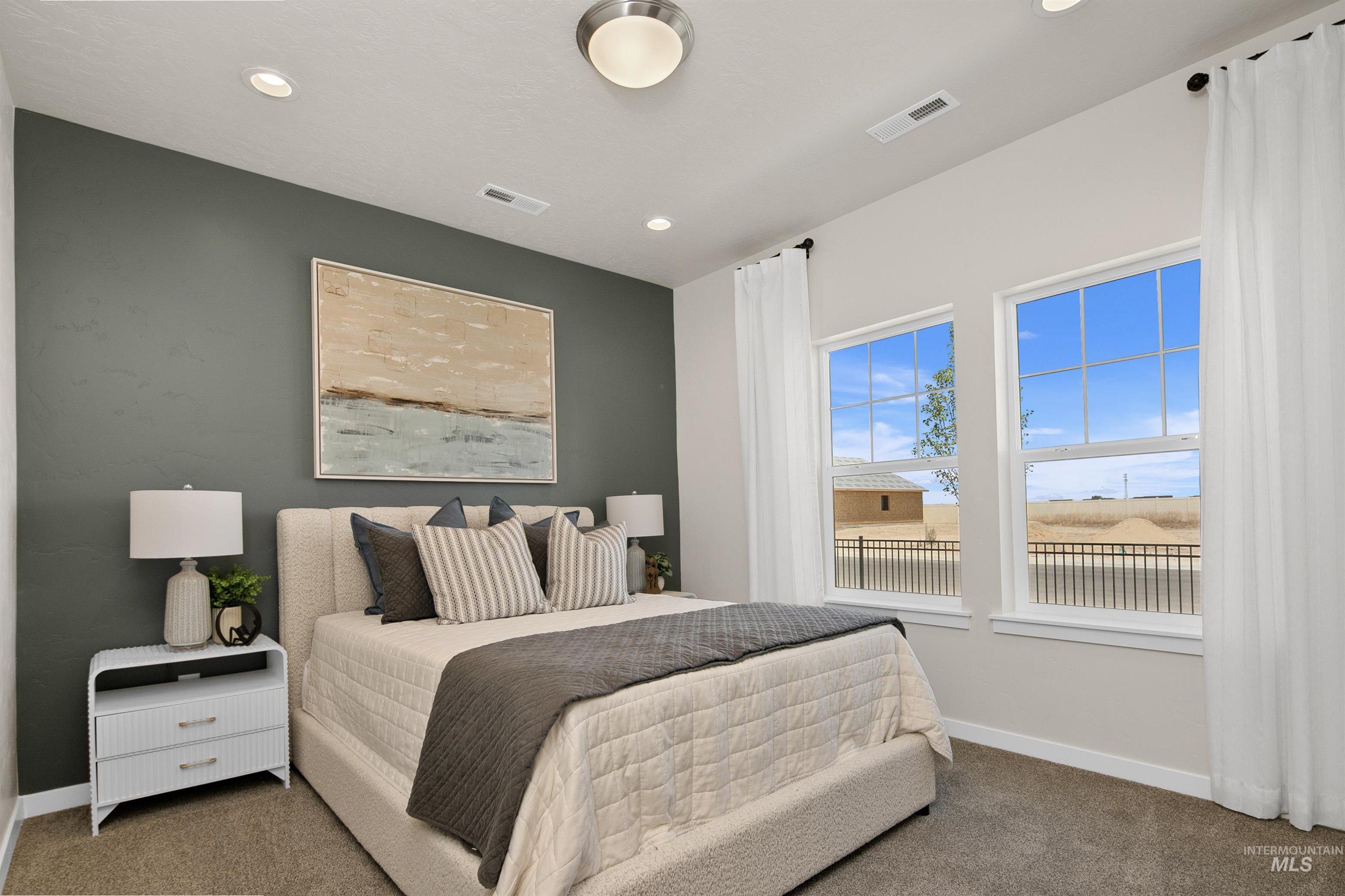 Carpeted bedroom with baseboards and recessed lighting