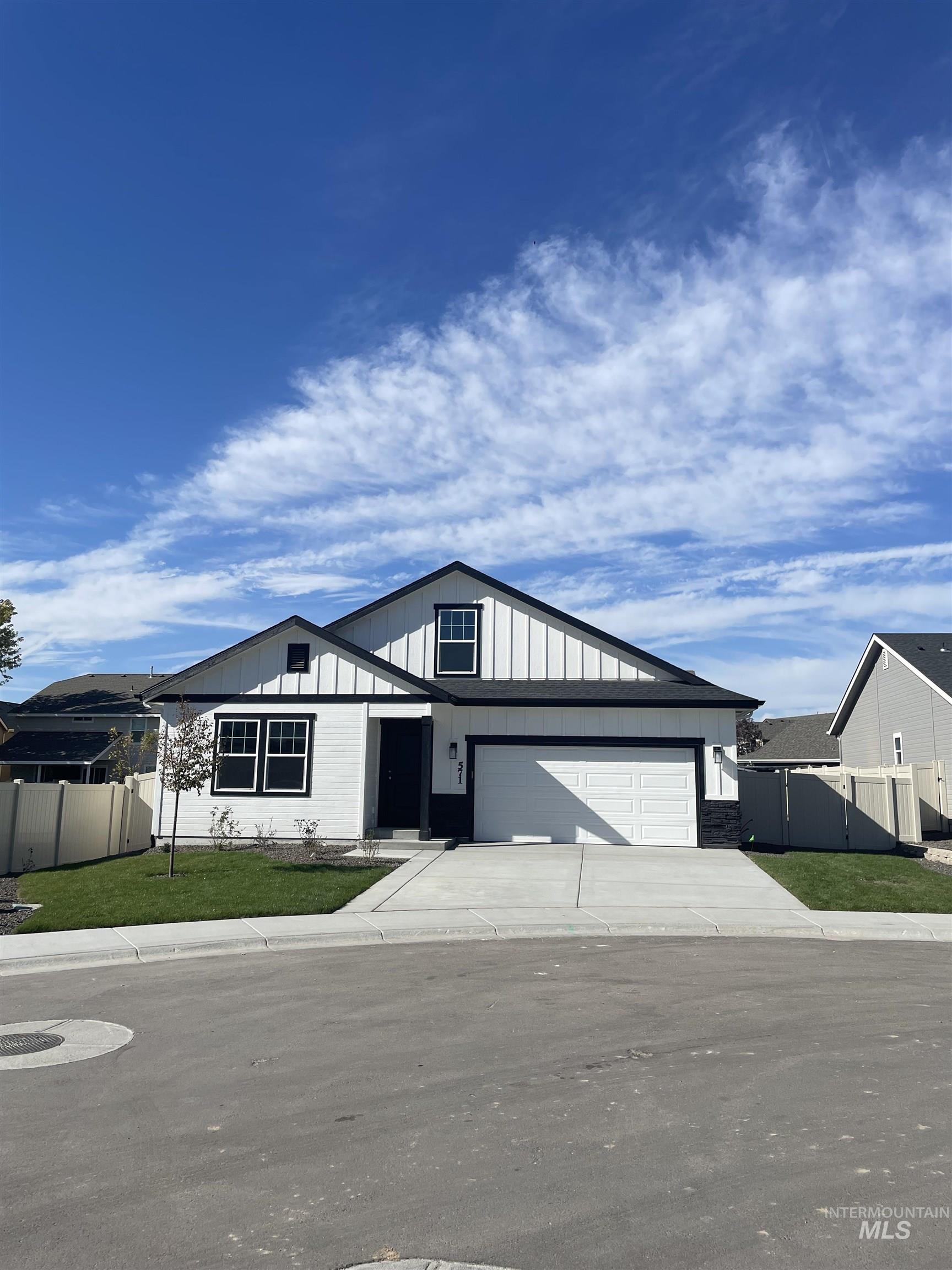 View of front of home featuring driveway and board and batten siding