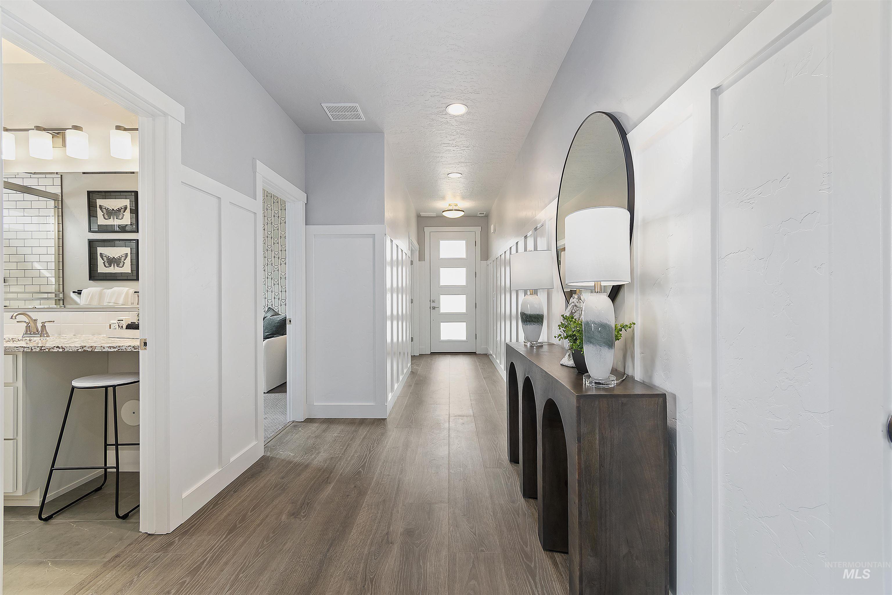 Hallway featuring light wood-type flooring and a sink