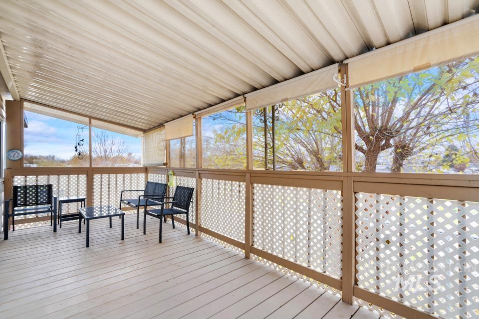 Wooden terrace featuring a sunroom