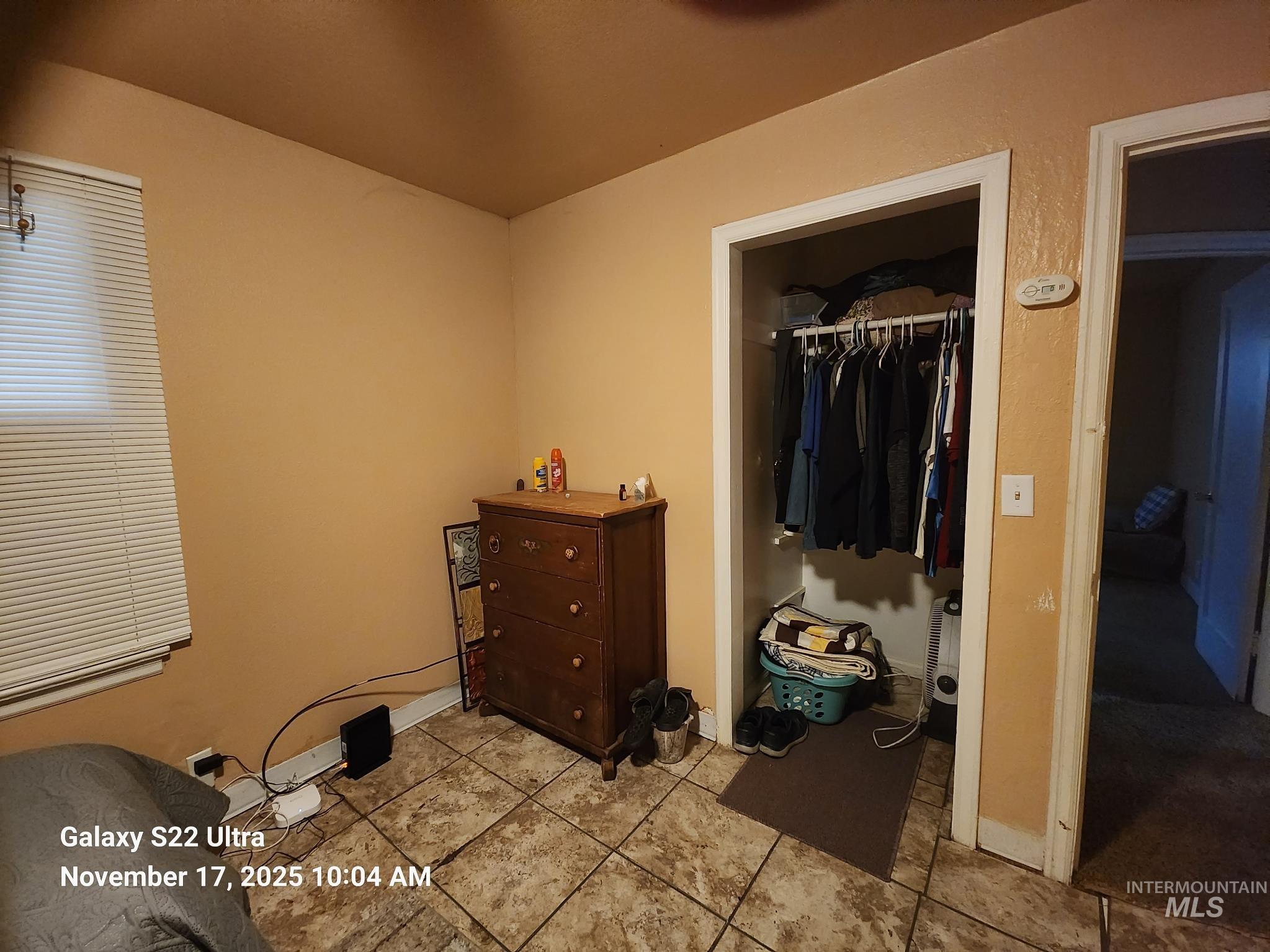 Bedroom featuring a closet and tile patterned flooring