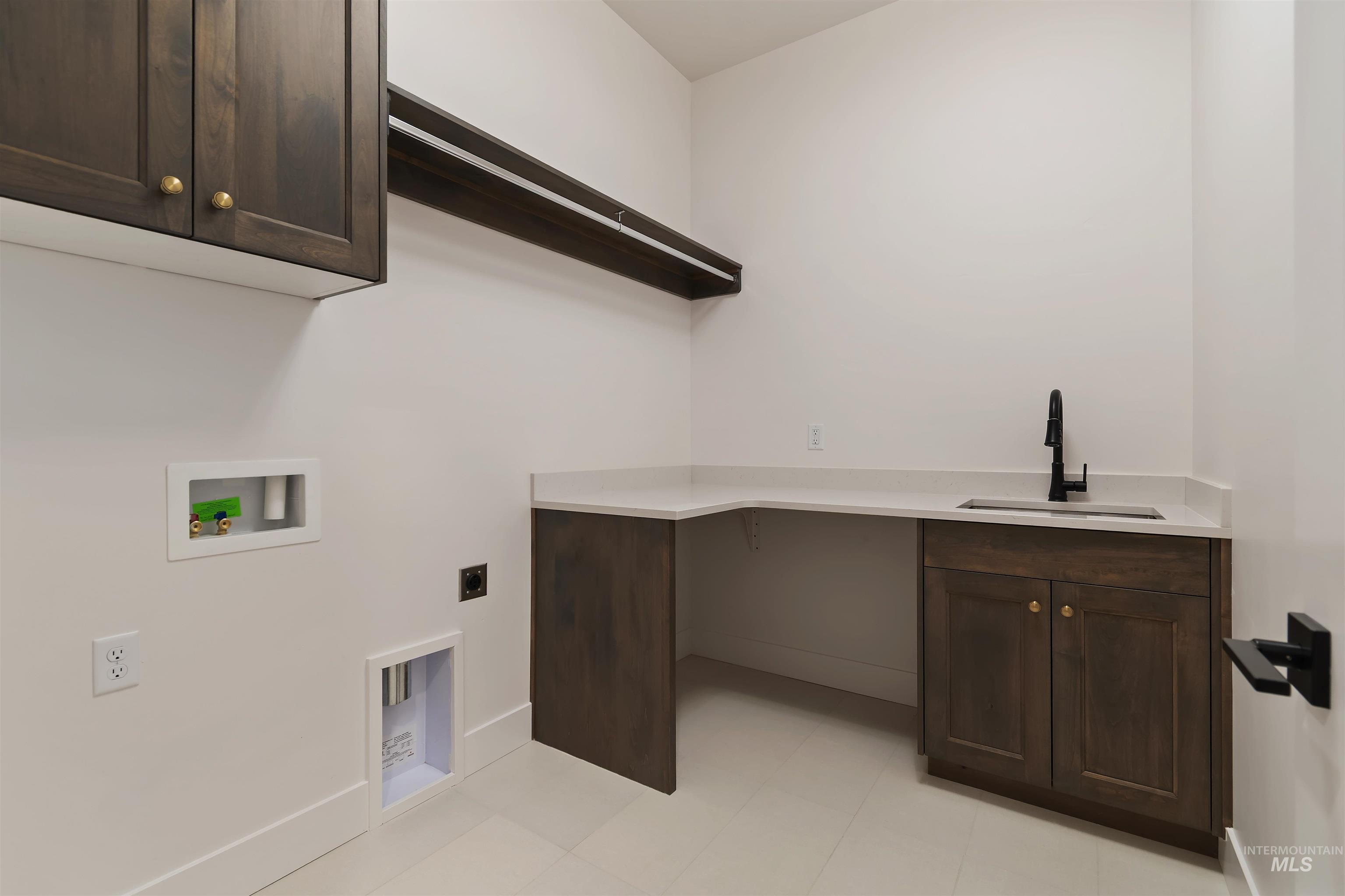 Laundry room featuring cabinet space, washer hookup, electric dryer hookup, and light tile patterned floors