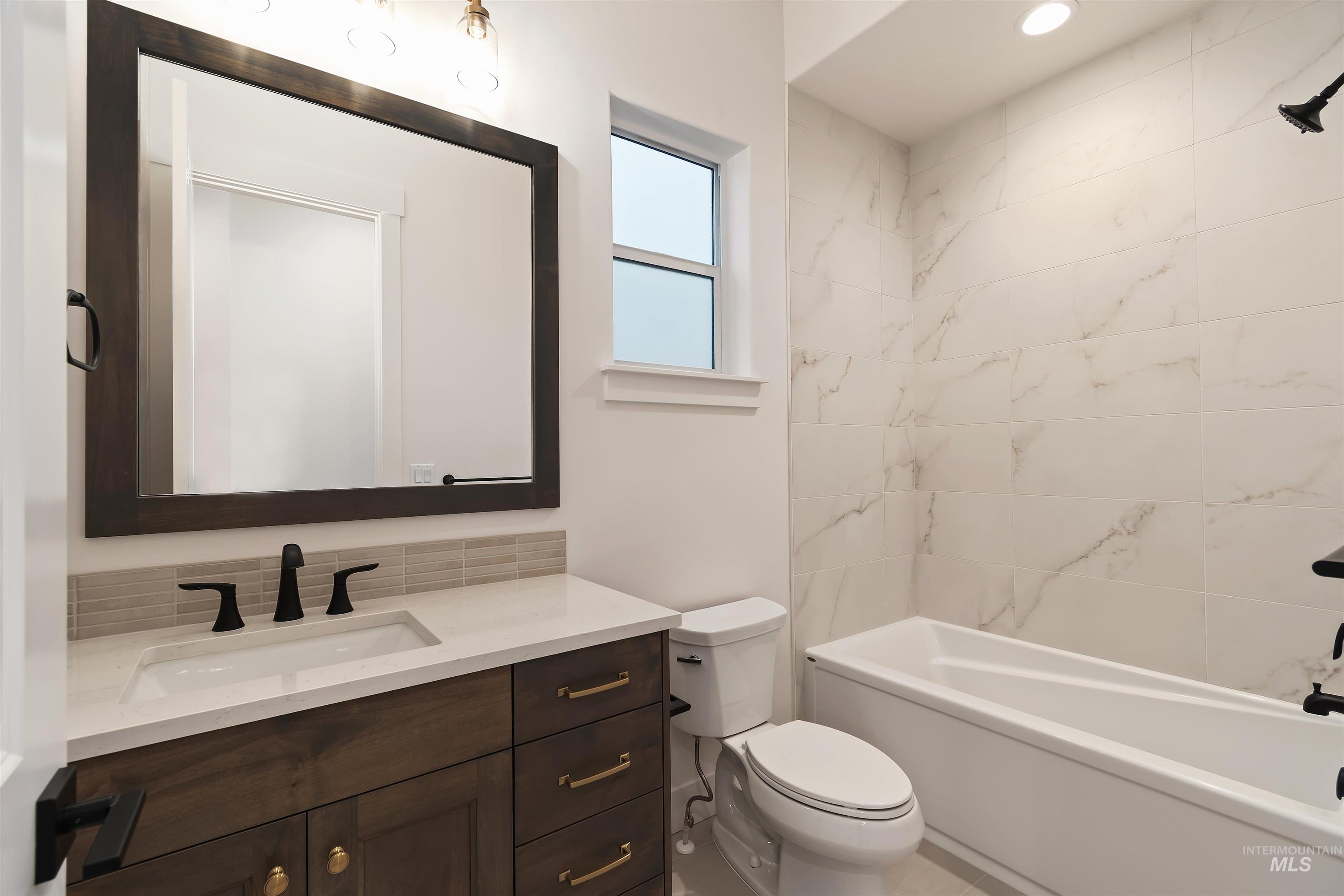 Bathroom with vanity and bathing tub / shower combination