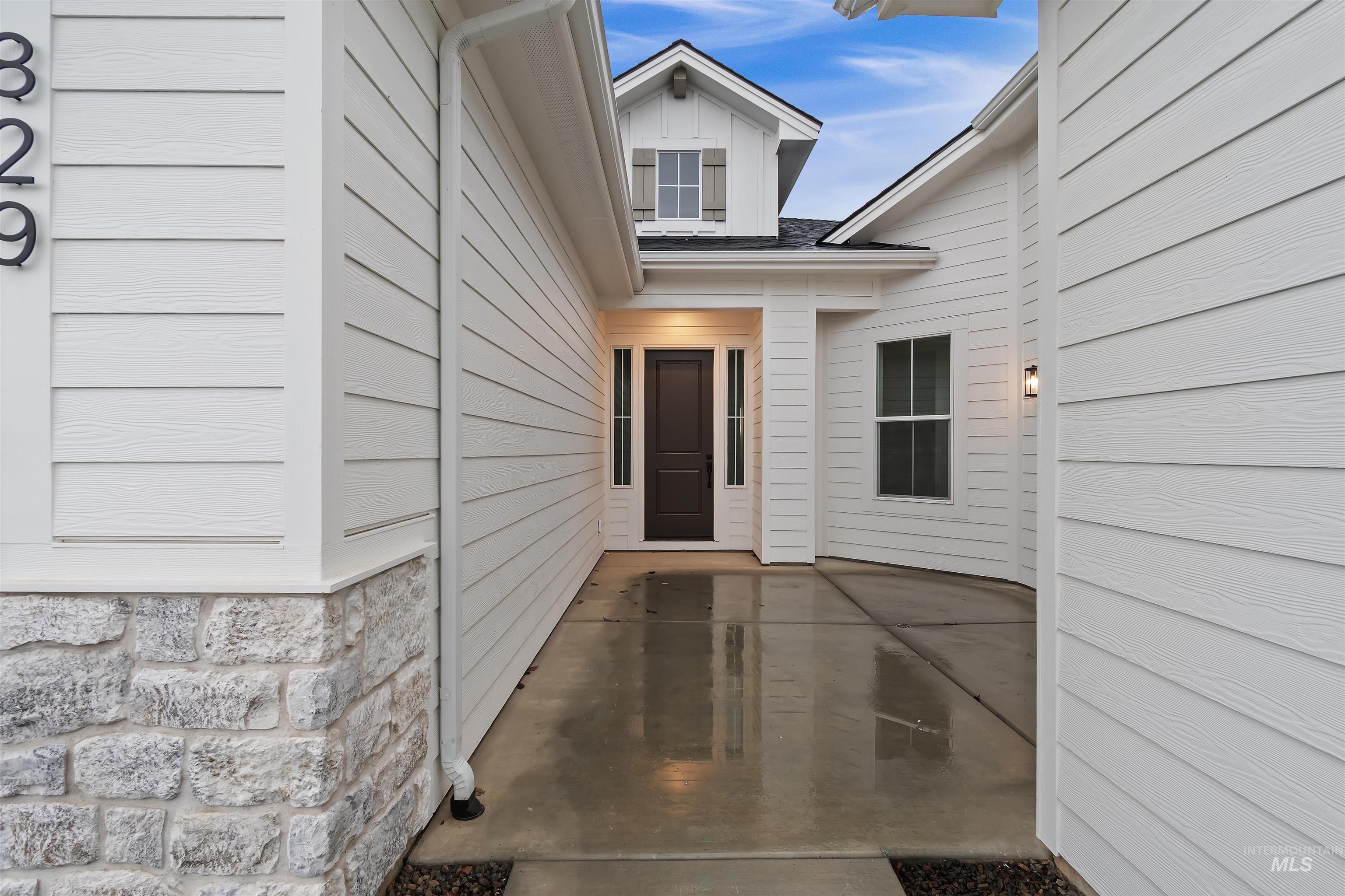 Property entrance with a patio area