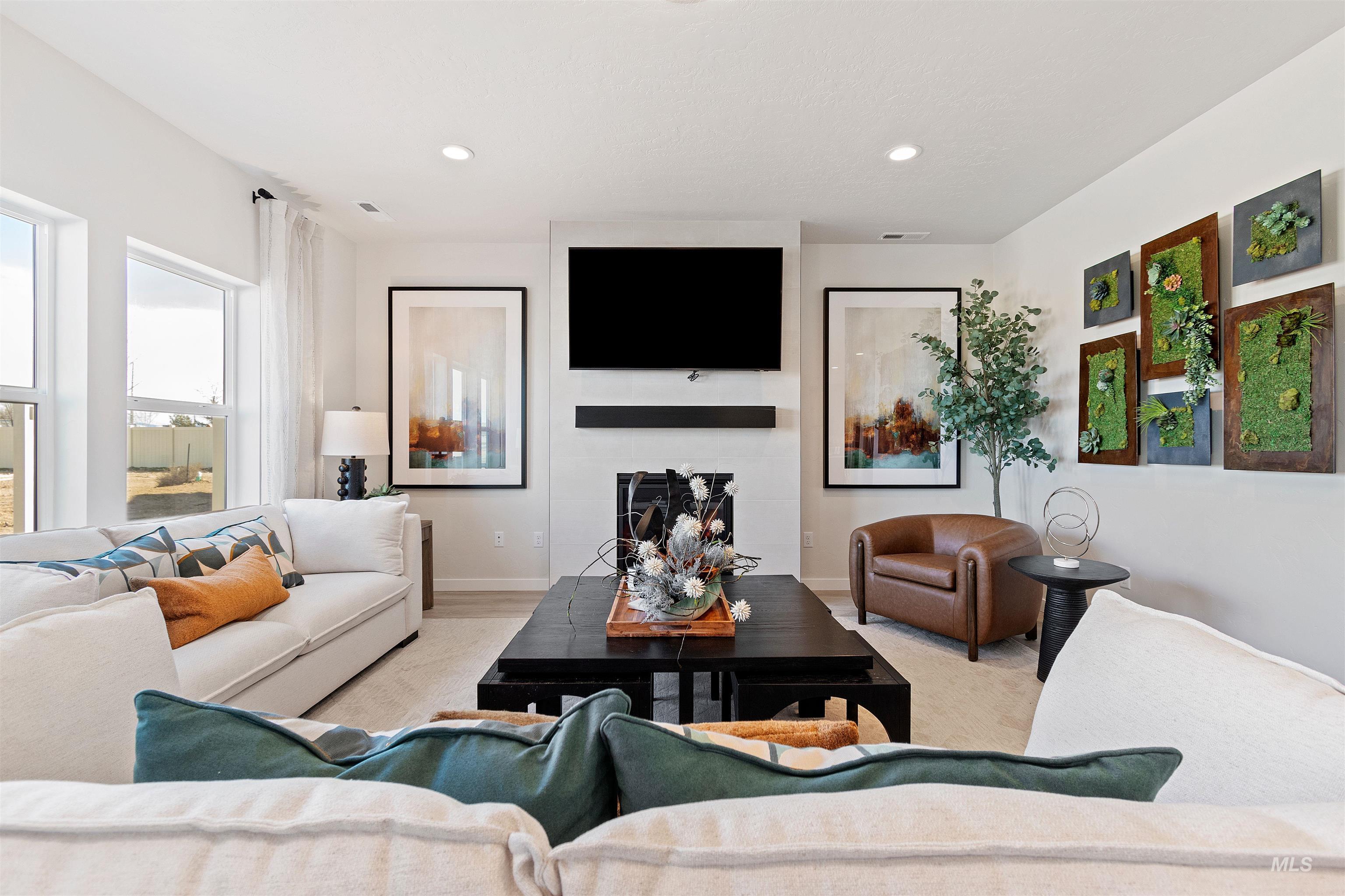 Living area featuring recessed lighting and a large fireplace