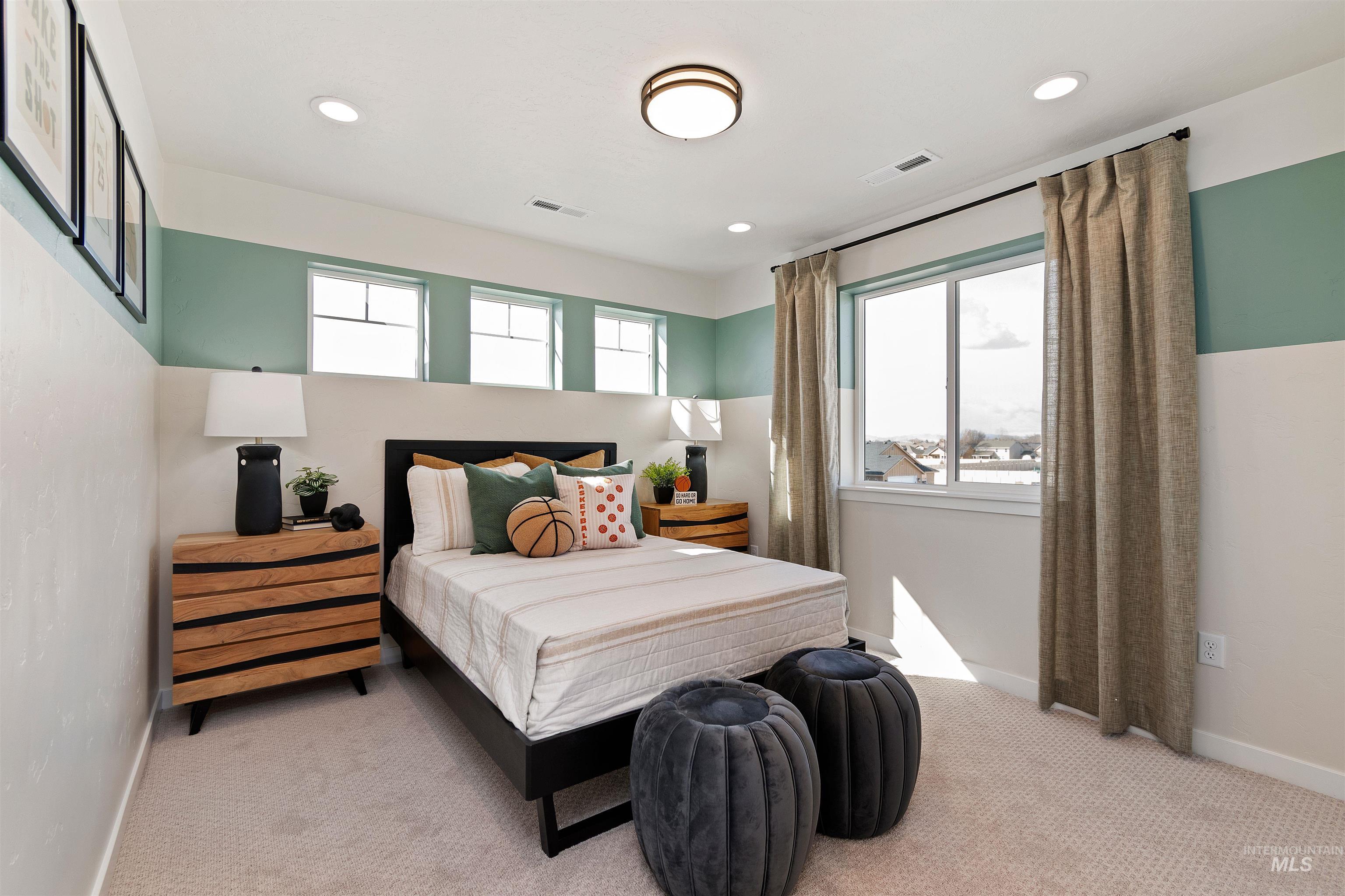 Carpeted bedroom with recessed lighting