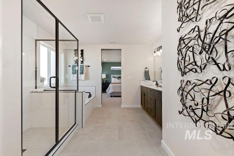 Ensuite bathroom with vanity, a stall shower, and a bath