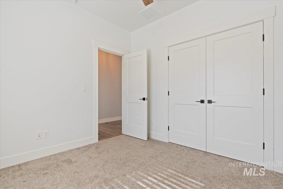 Unfurnished bedroom with carpet flooring and a closet