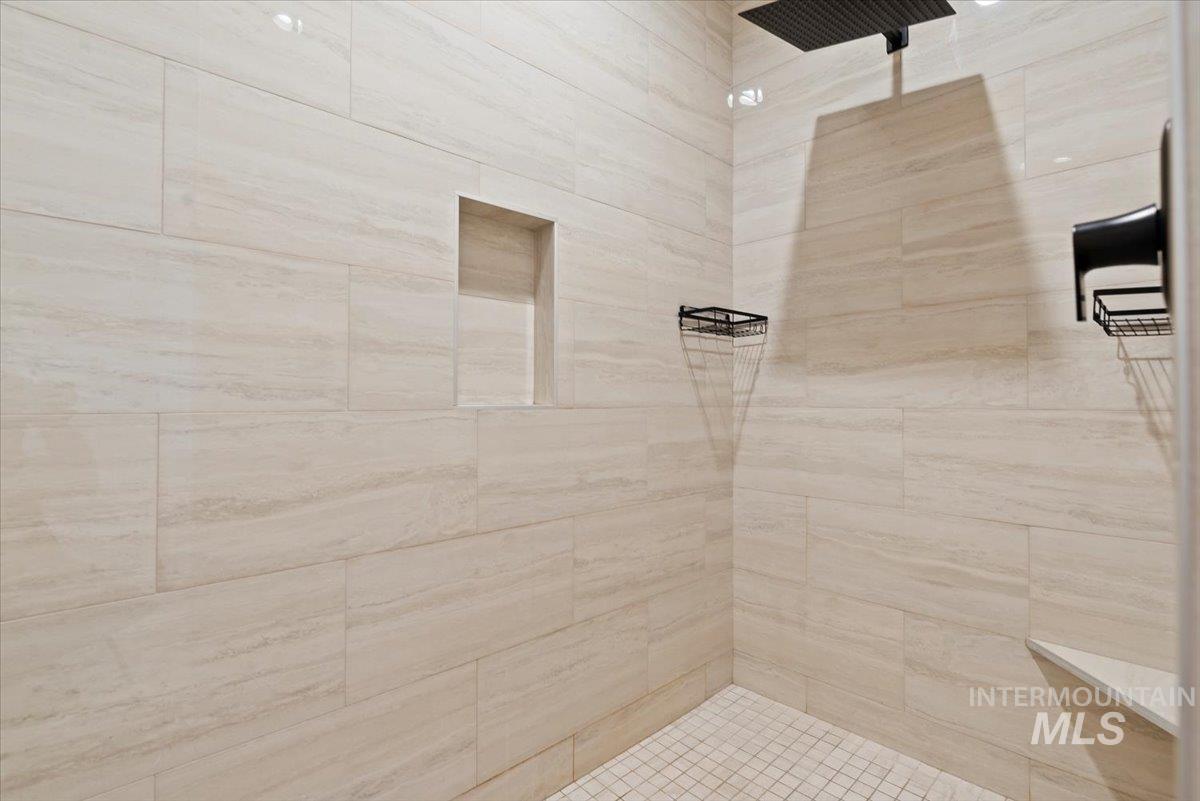 Full bath featuring tiled shower