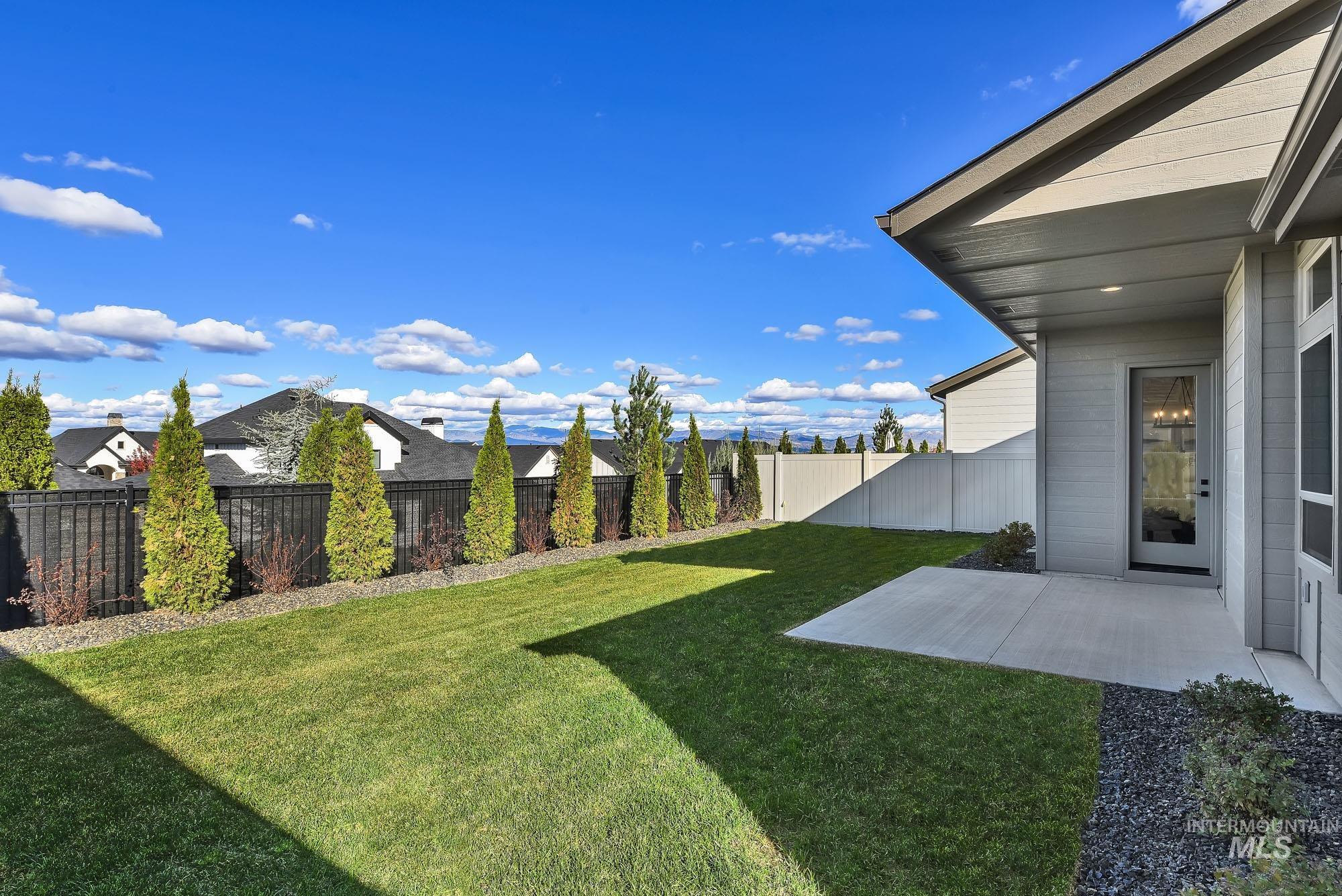 Fenced backyard w/ Foothills View and oversized covered patio