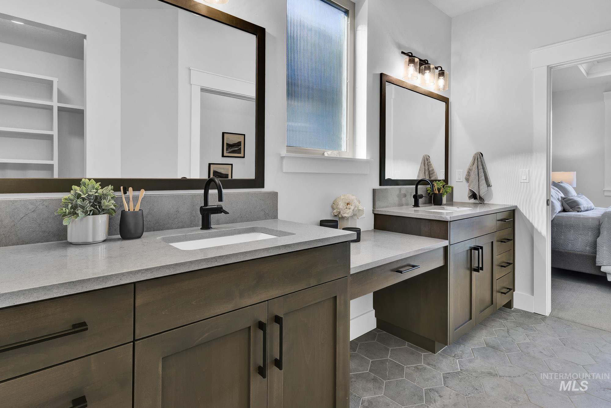 Ensuite bathroom featuring vanity and light tile patterned floors